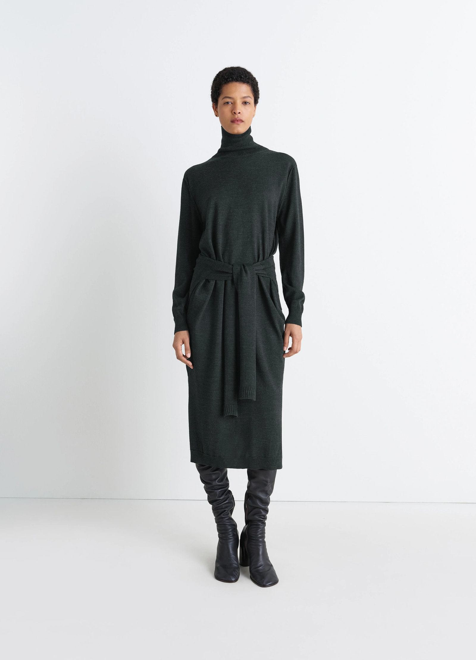 Lemaire trompe loeil dress in dark merino wool blend, model shot, side view turtleneck sweater dress