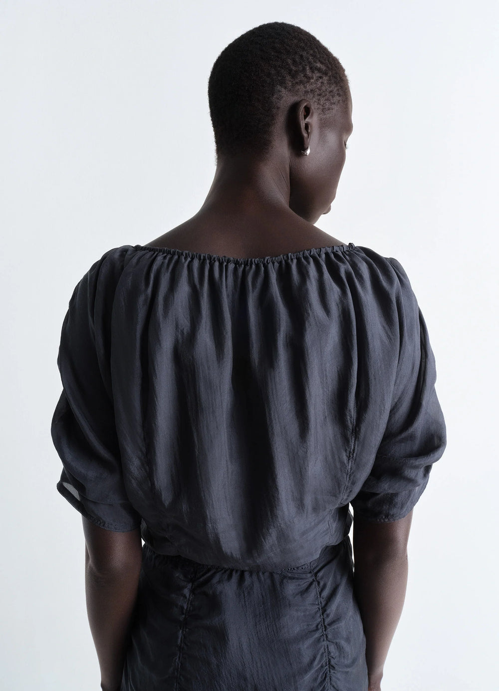 Lemaire Midi Dress in Silk Chiffon Gray, model shot, over-the-shoulder view cinched neckline detail