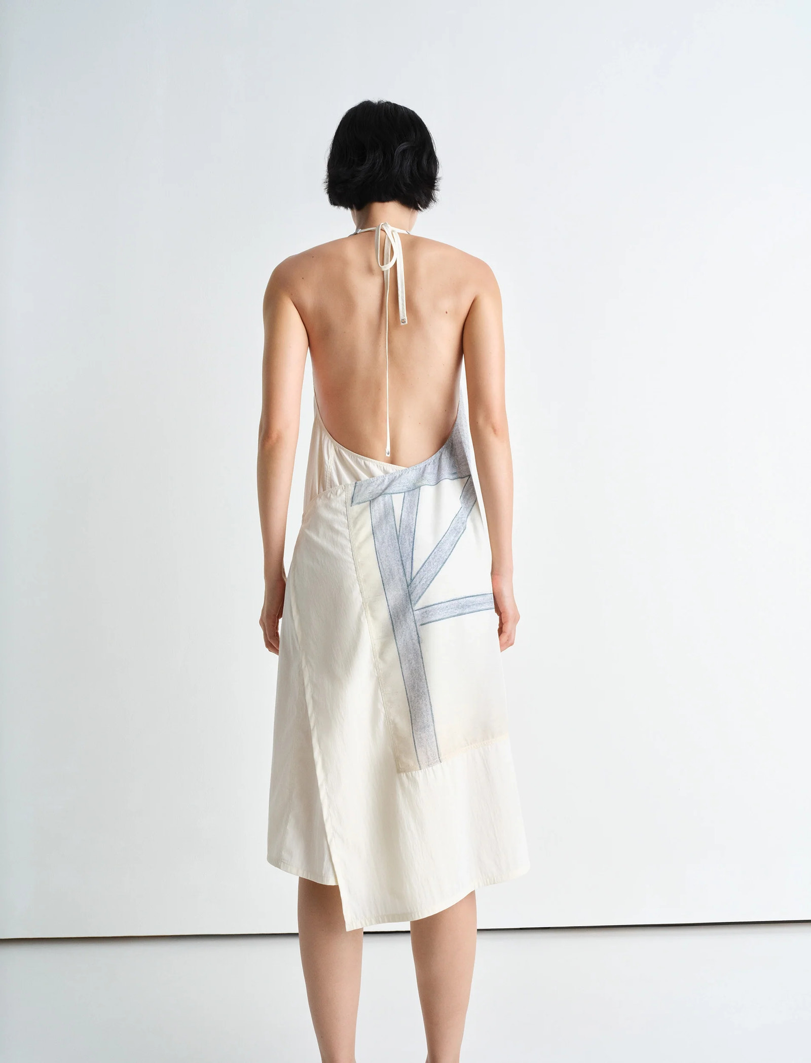 Philippe weisbecker apron dress in printed viscose technical lyocell, model shot, back view open back with tie straps