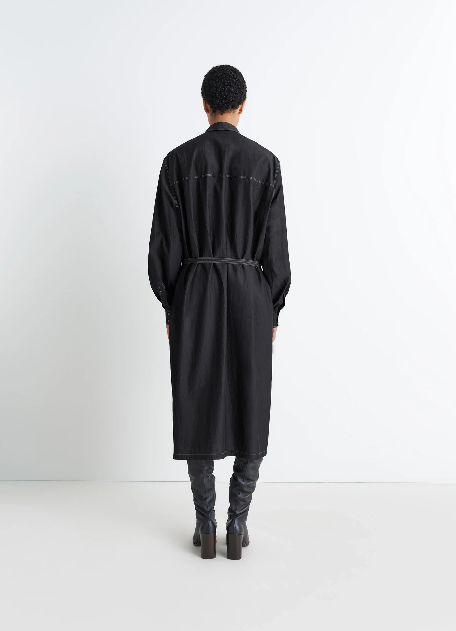 Asymmetrical shirt dress in black cotton crepe, model shot, back view belted back, long hem