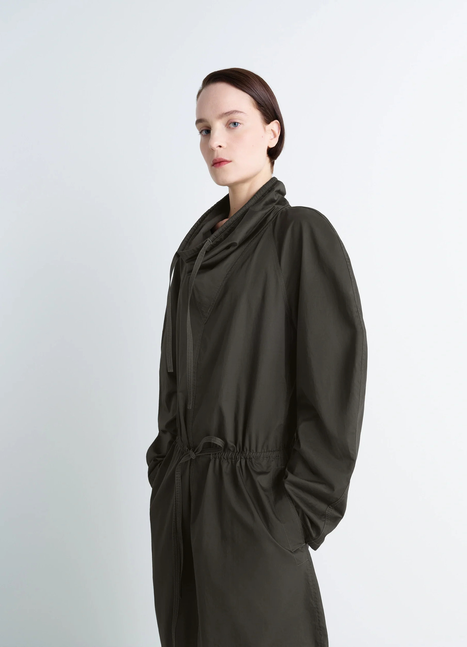 Lemaire vareuse dress in olive lightweight cotton, model shot, three-quarter portrait view high collar drawstring neckline