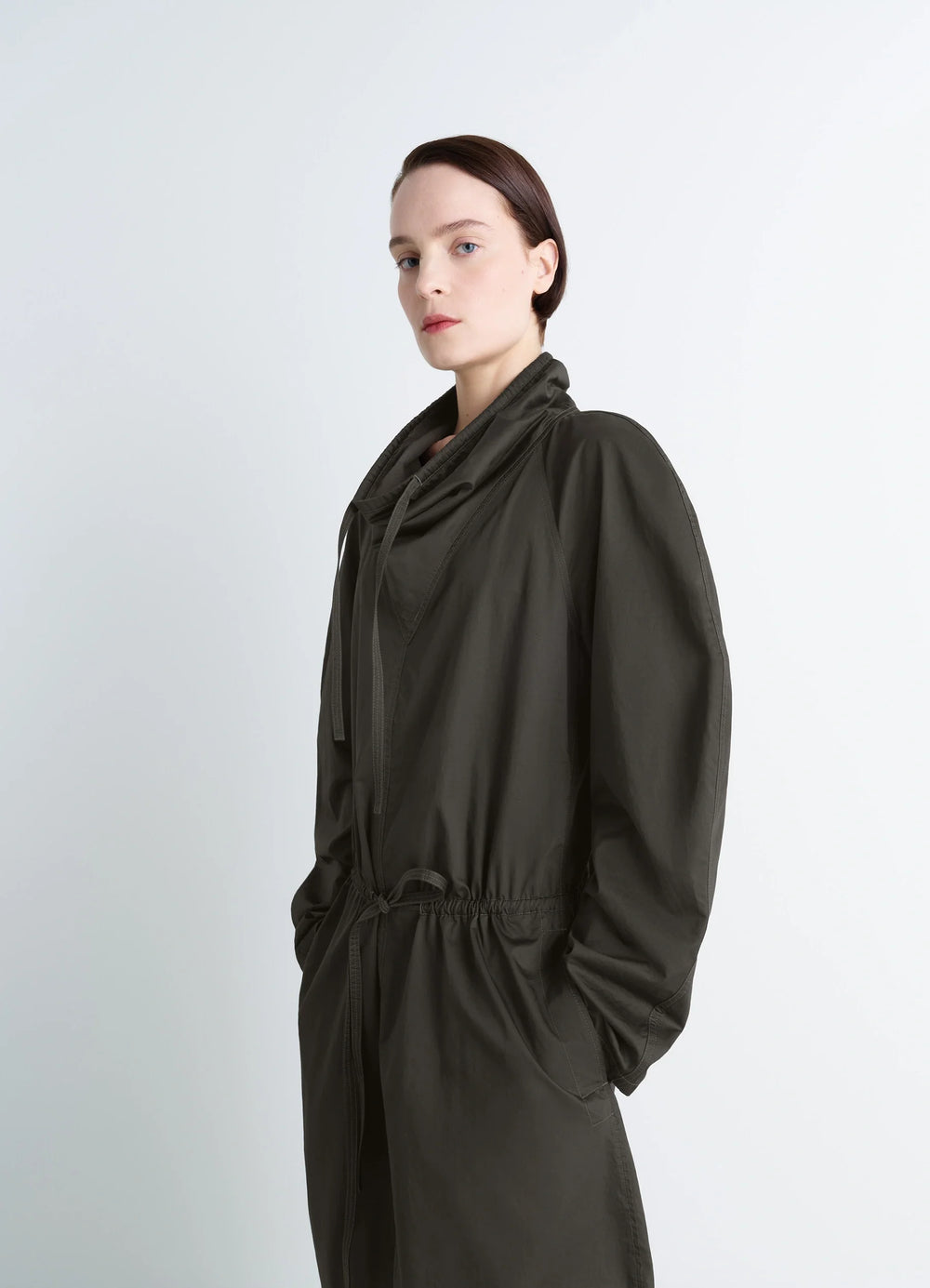 Lemaire Vareuse Dress in Olive Lightweight Cotton, model shot, three-quarter portrait view high collar drawstring neckline