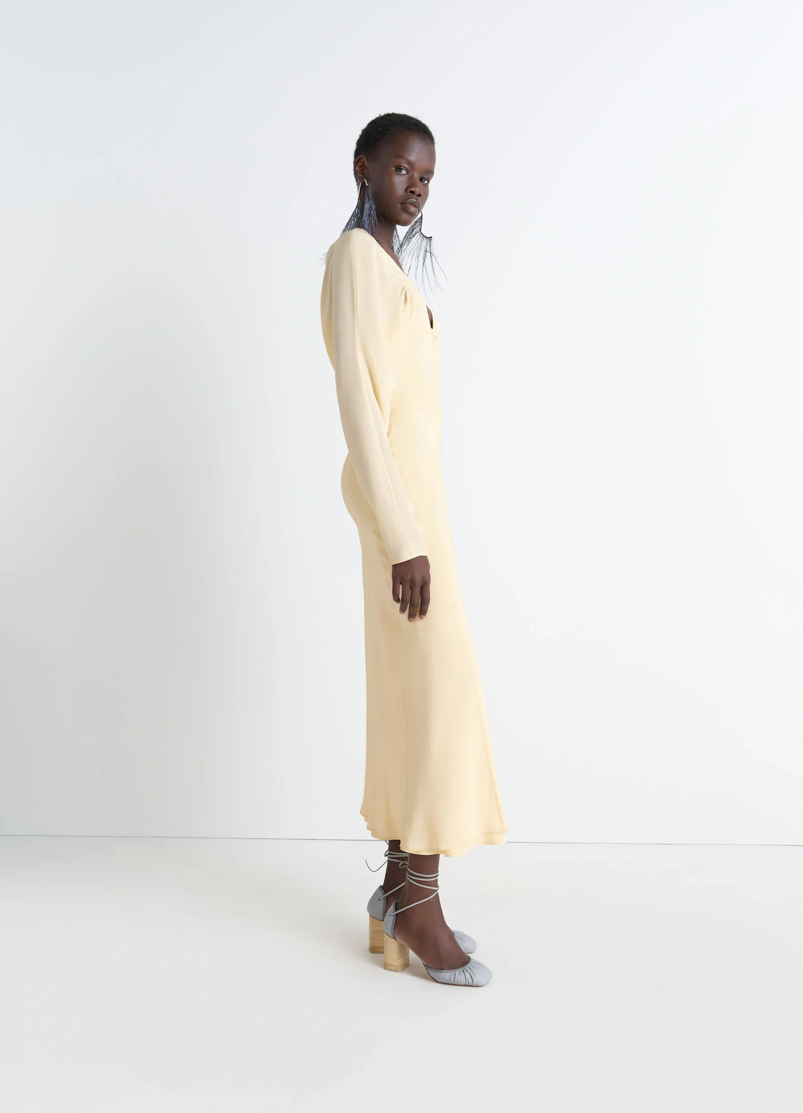 Bias cut dress in silk crepe de chine, model shot, side view long sleeves