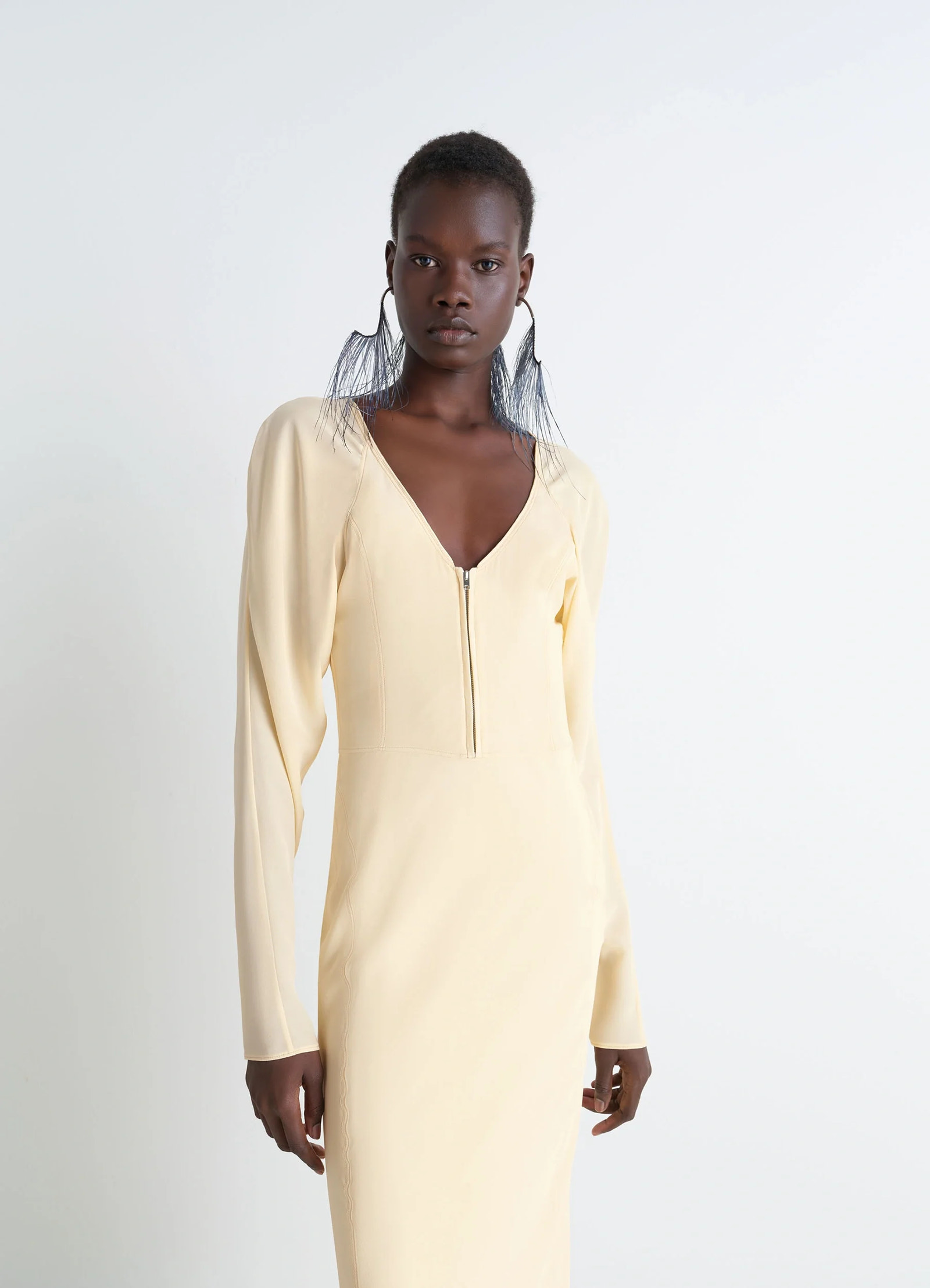 Bias cut dress in silk crepe de chine, model shot, three-quarter view deep v-neck, zipper