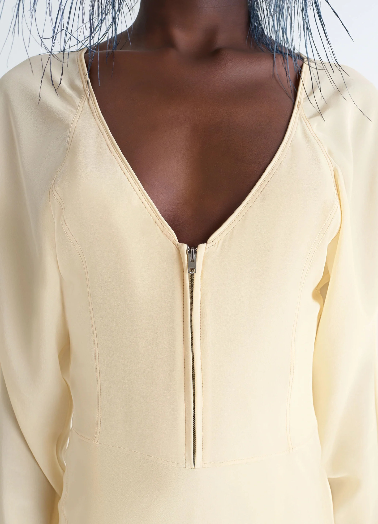 Bias cut dress in silk crepe de chine, model shot, detail close-up view deep v-neck zipper detail