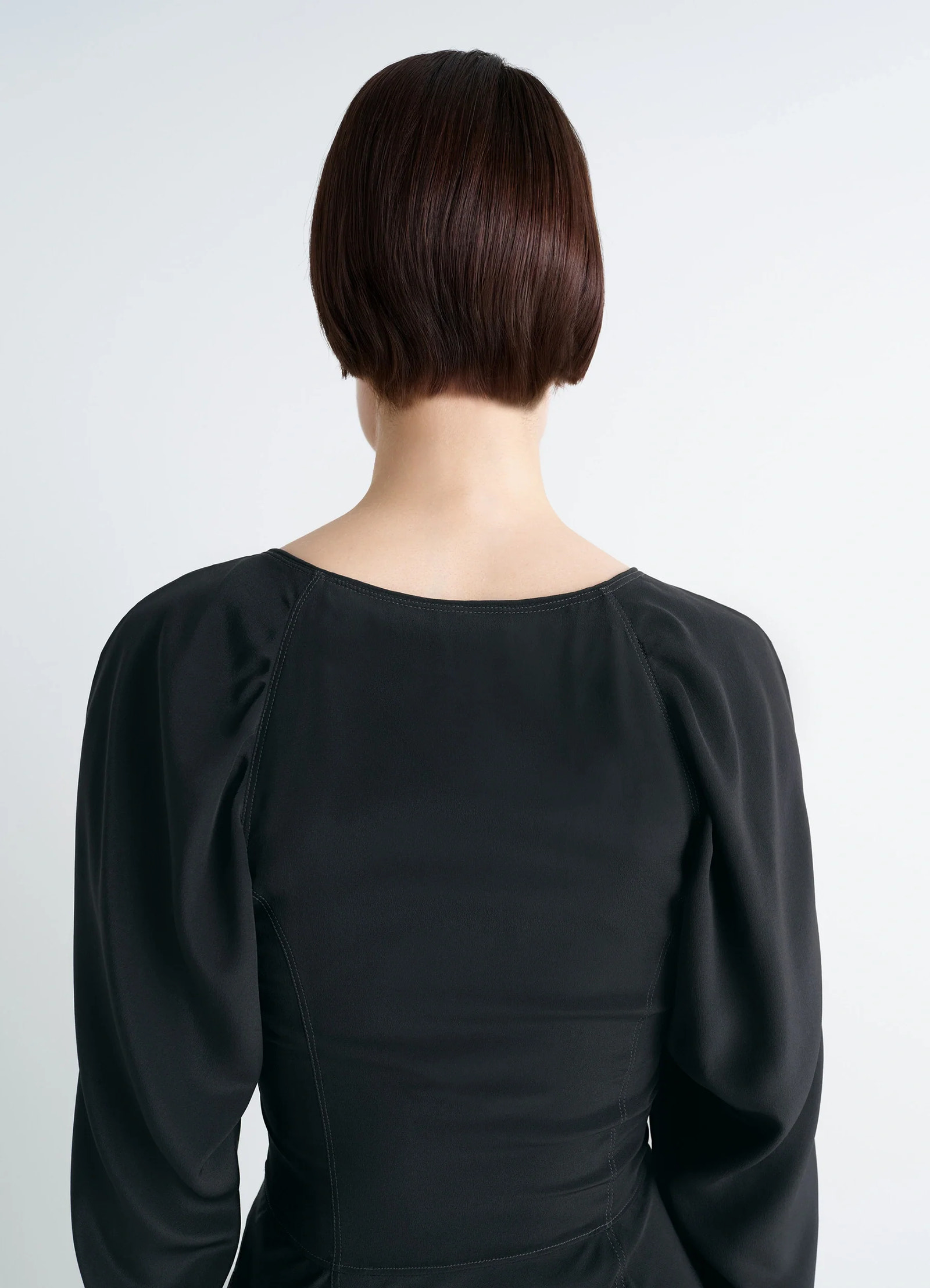 Bias cut dress in black silk crepe de chine, model shot, back view puff sleeves detail