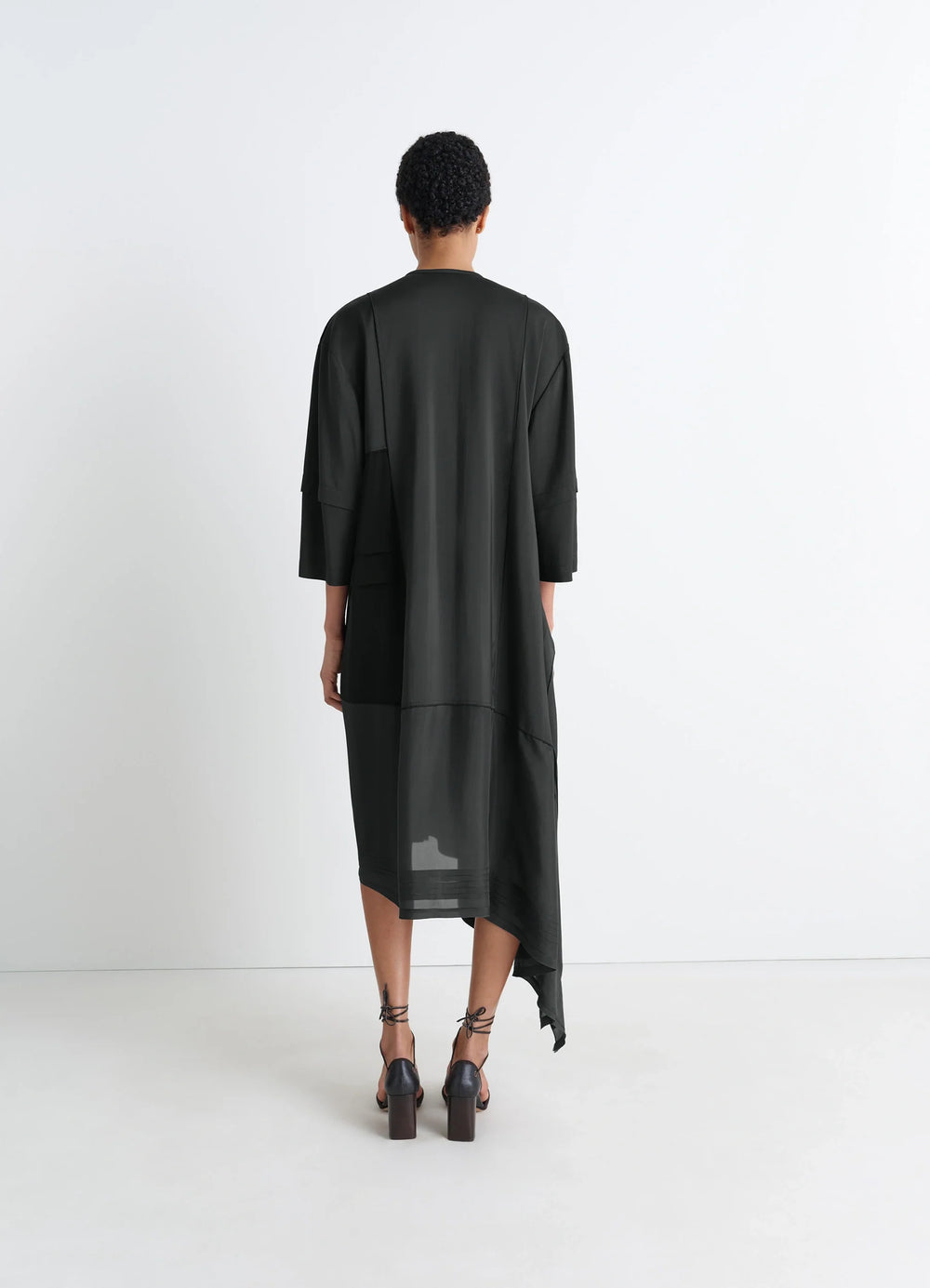 Blouse Dress with Pleats in Black crêpe de Chine, model shot, back view elongated cut, sheer back