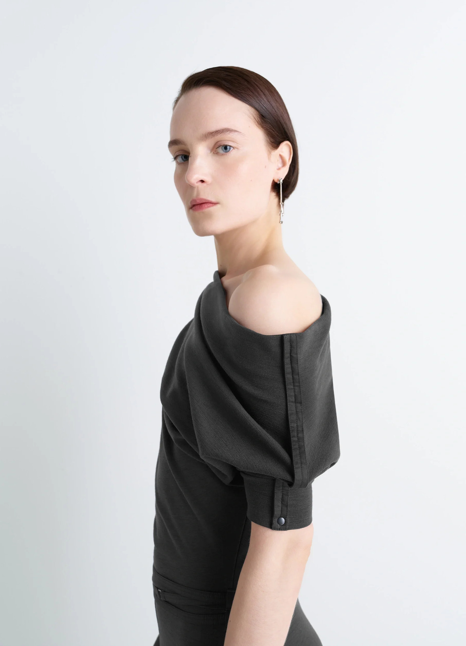 Lemaire twisted hem dress in wool viscose-blend jersey, model shot, off-shoulder close-up gathered sleeve feature
