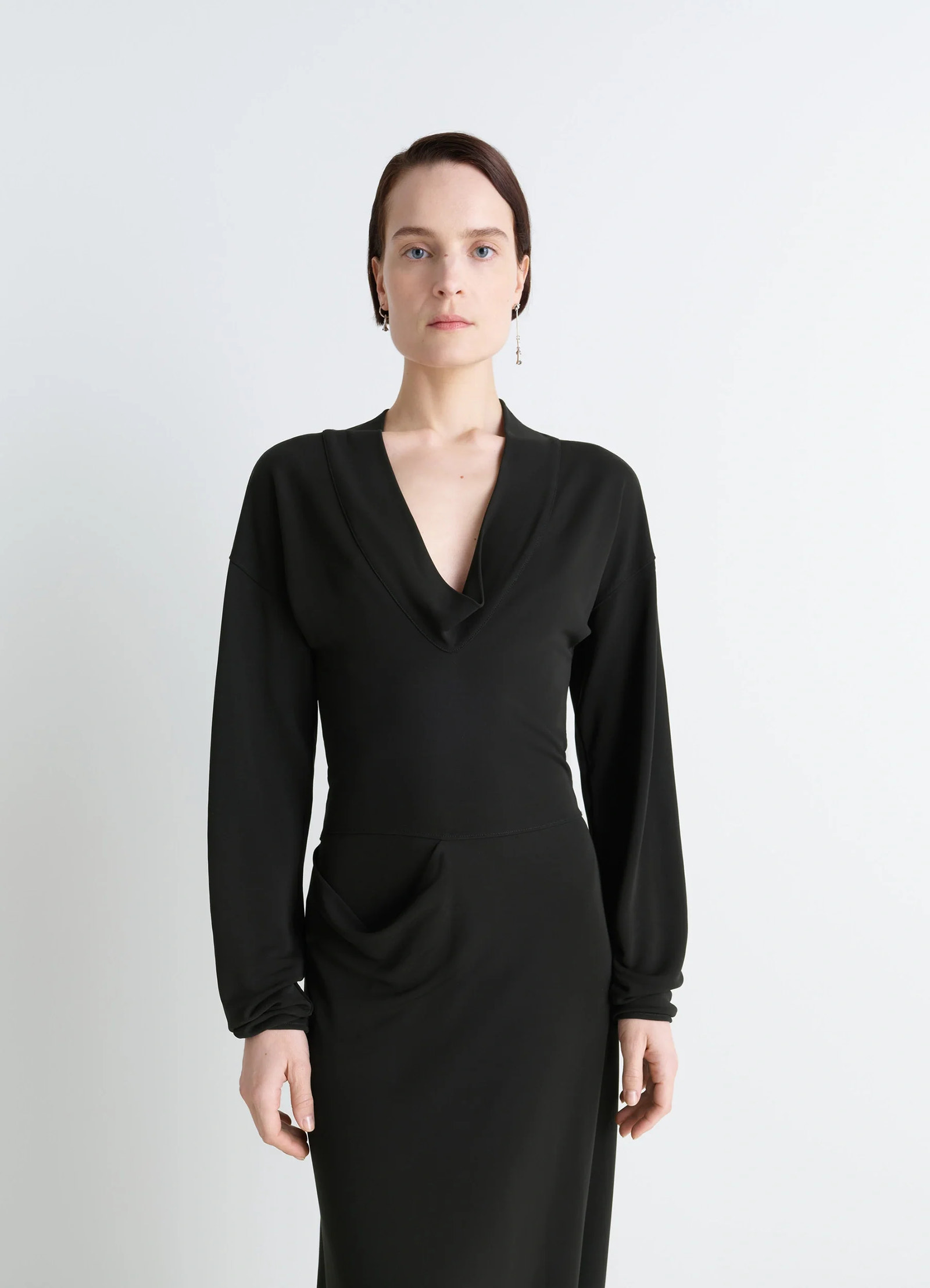 Lemaire v-neck dress in black viscose crepe jersey, model shot, half front view long sleeves fitted