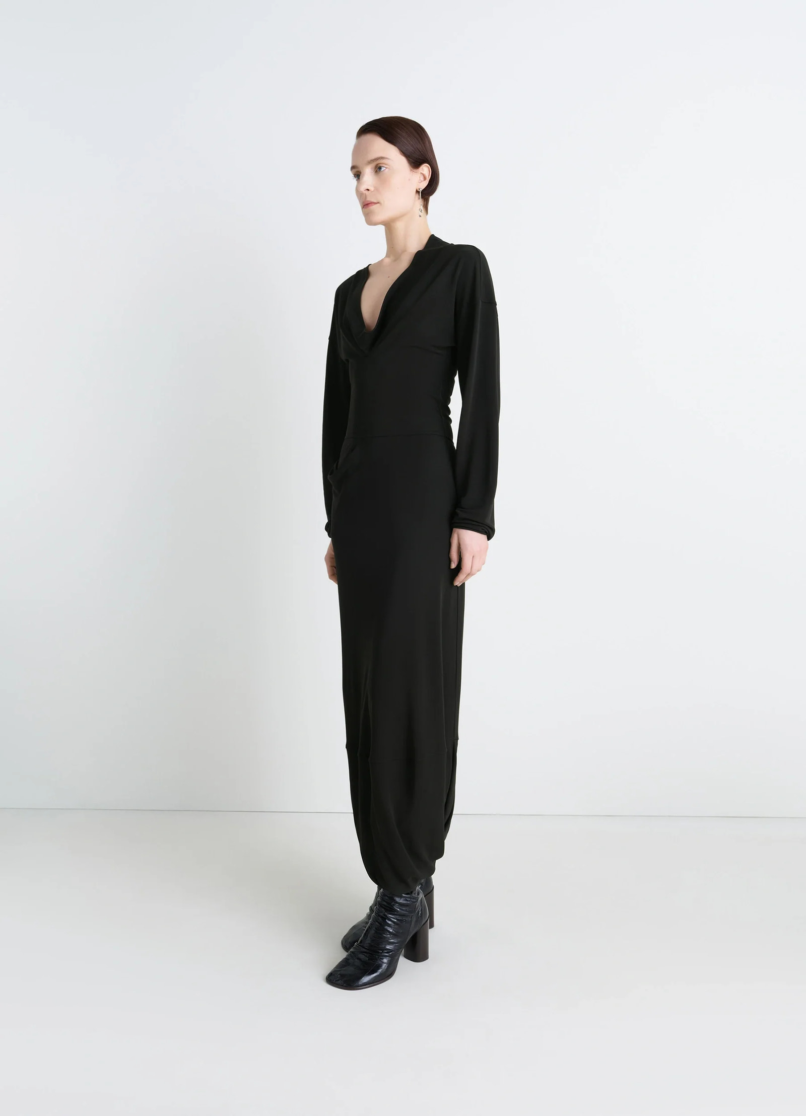 Lemaire v-neck dress in black viscose crepe jersey, model shot, side view asymmetrical hem