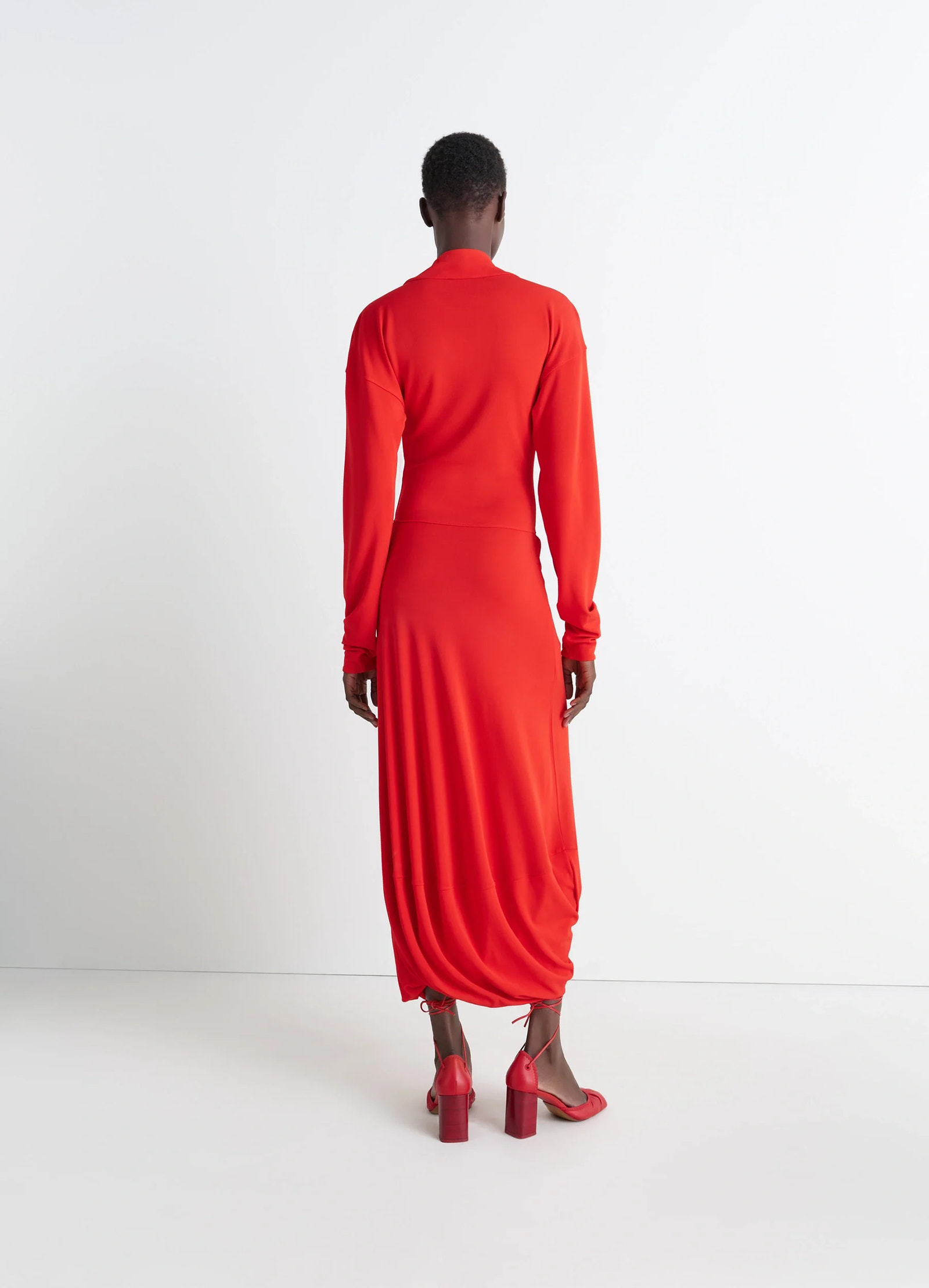 Lemaire v-neck dress in red viscose crepe jersey, model shot, back view fitted waist, gathered hem
