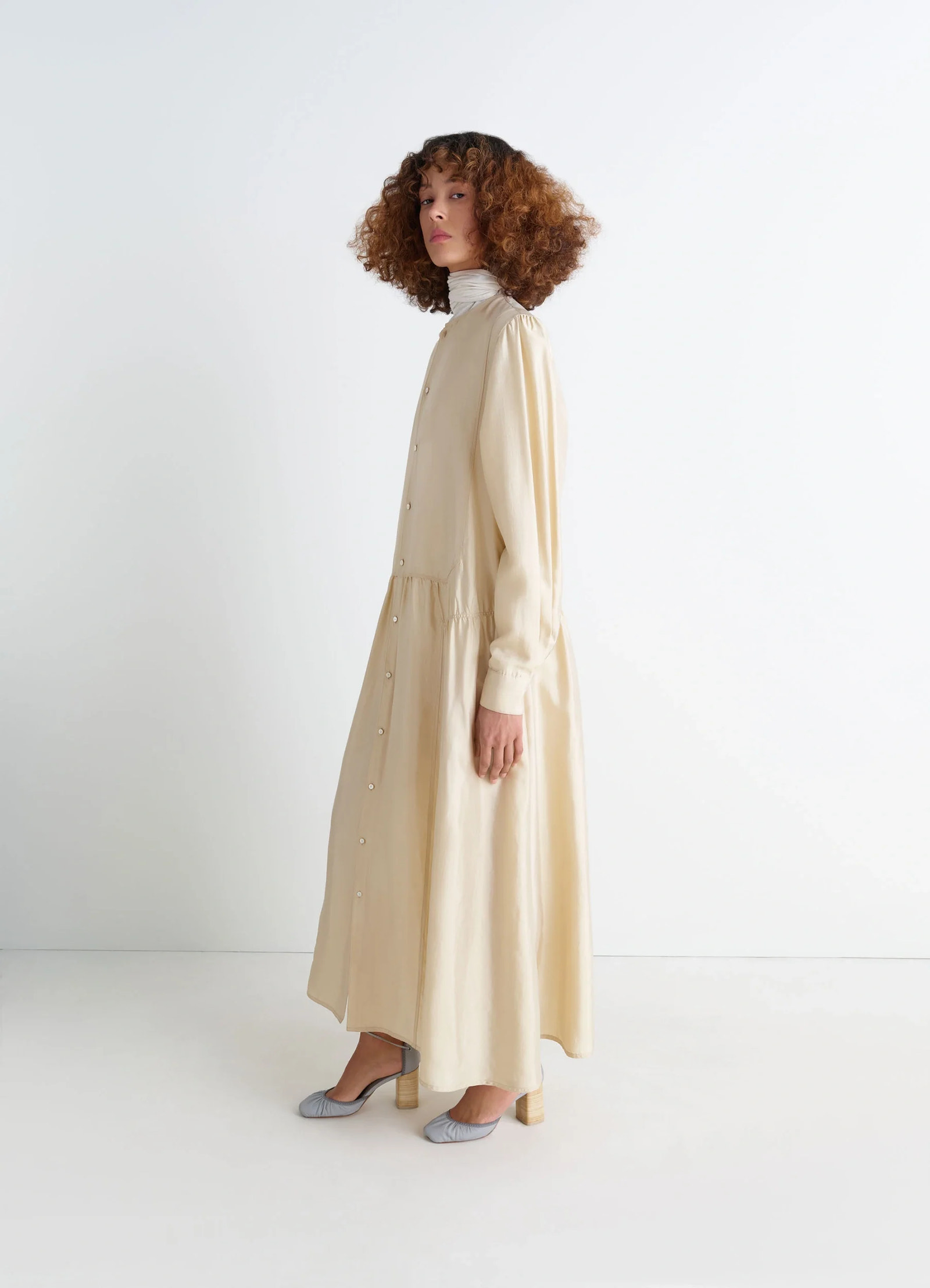 Lemaire buttoned dress in soft shiny silk, model shot, side view light patina finish