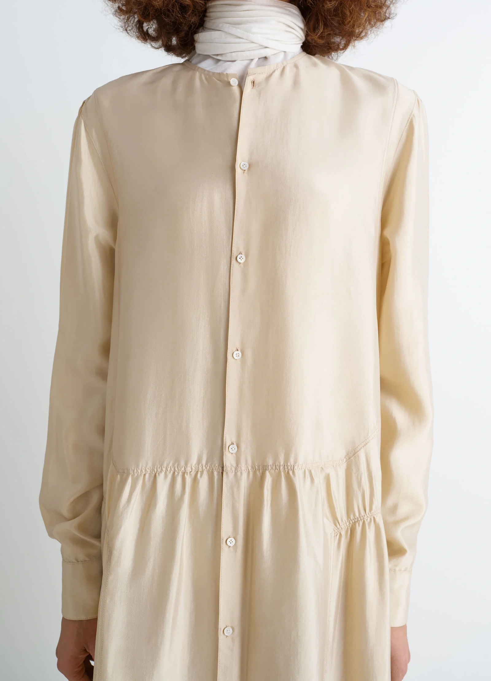 Lemaire buttoned dress in soft shiny silk, model shot, close-up view buttoned placket
