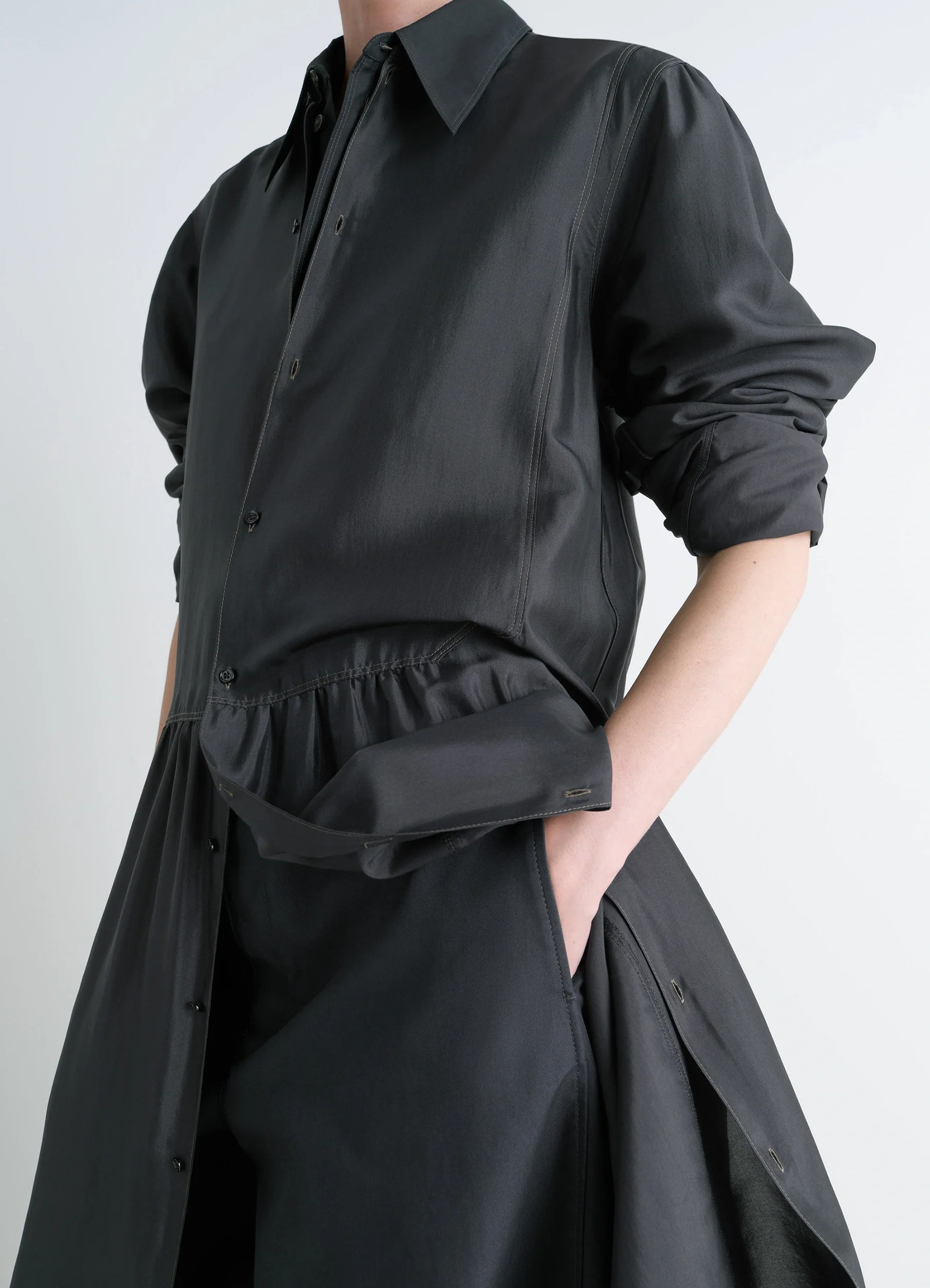 Lemaire buttoned dress in silk soft shiny black, model shot, close-up view buttoned cuffs, pocket