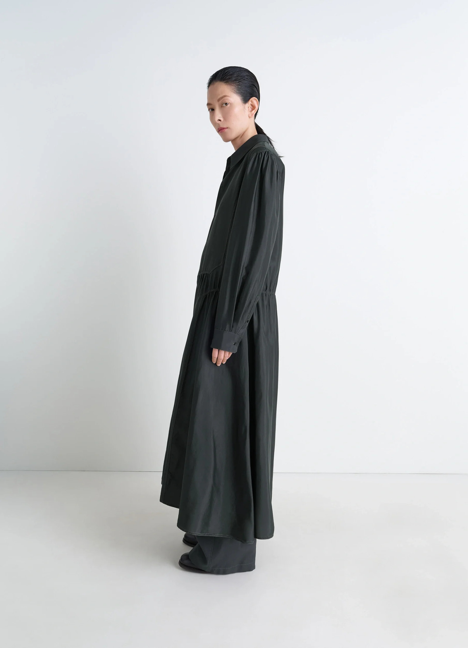 Lemaire buttoned dress in silk soft shiny black, model shot, side view long silhouette