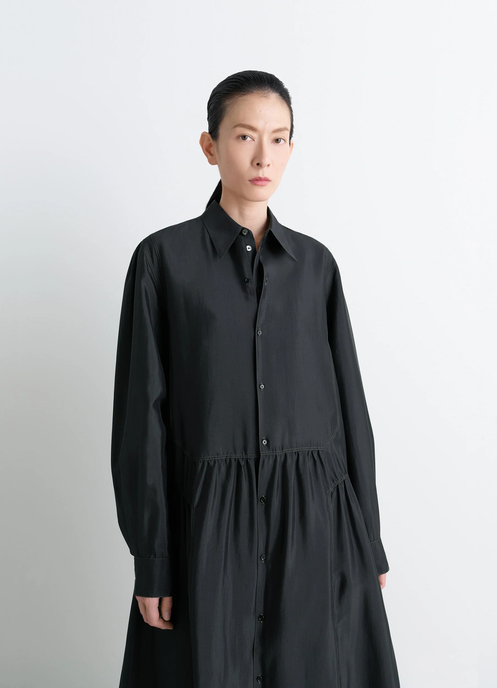 Lemaire buttoned dress in silk soft shiny black, model shot, upper-body view buttoned front, collar