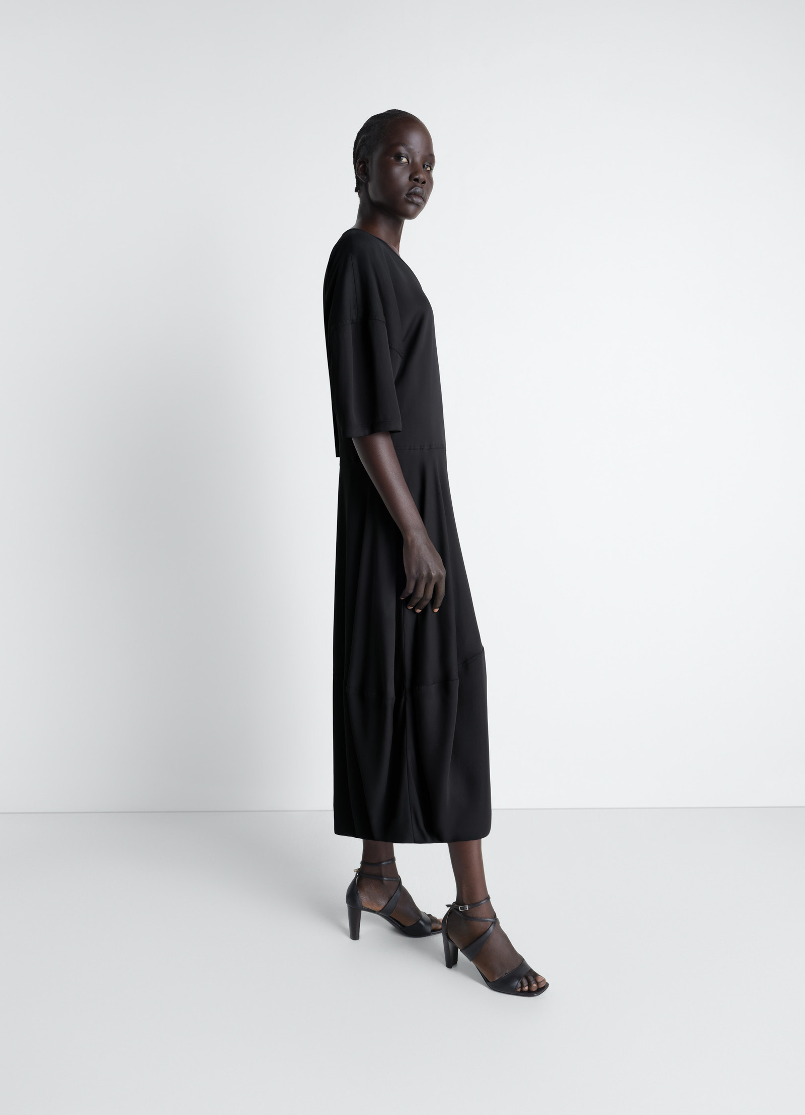 Balloon dress in crepe de chine viscose, model shot, three-quarter view midi length hem