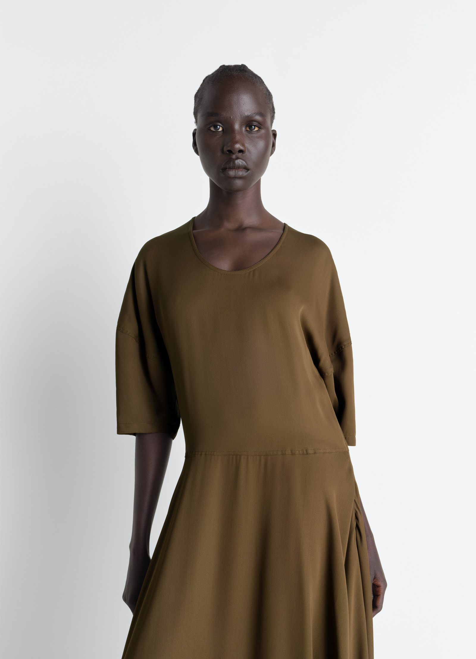 Lemaire balloon dress in crepe de chine viscose, model shot, close-up view flowing fabric detail