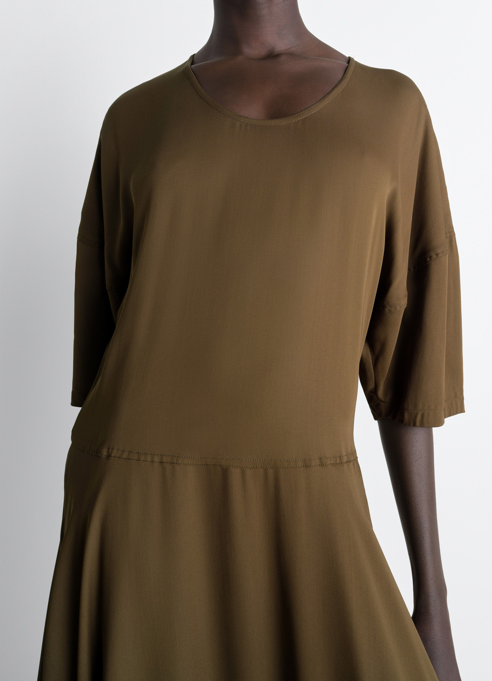 Lemaire balloon dress in crepe de chine viscose, model shot, midsection detail view high neckline, smooth waist