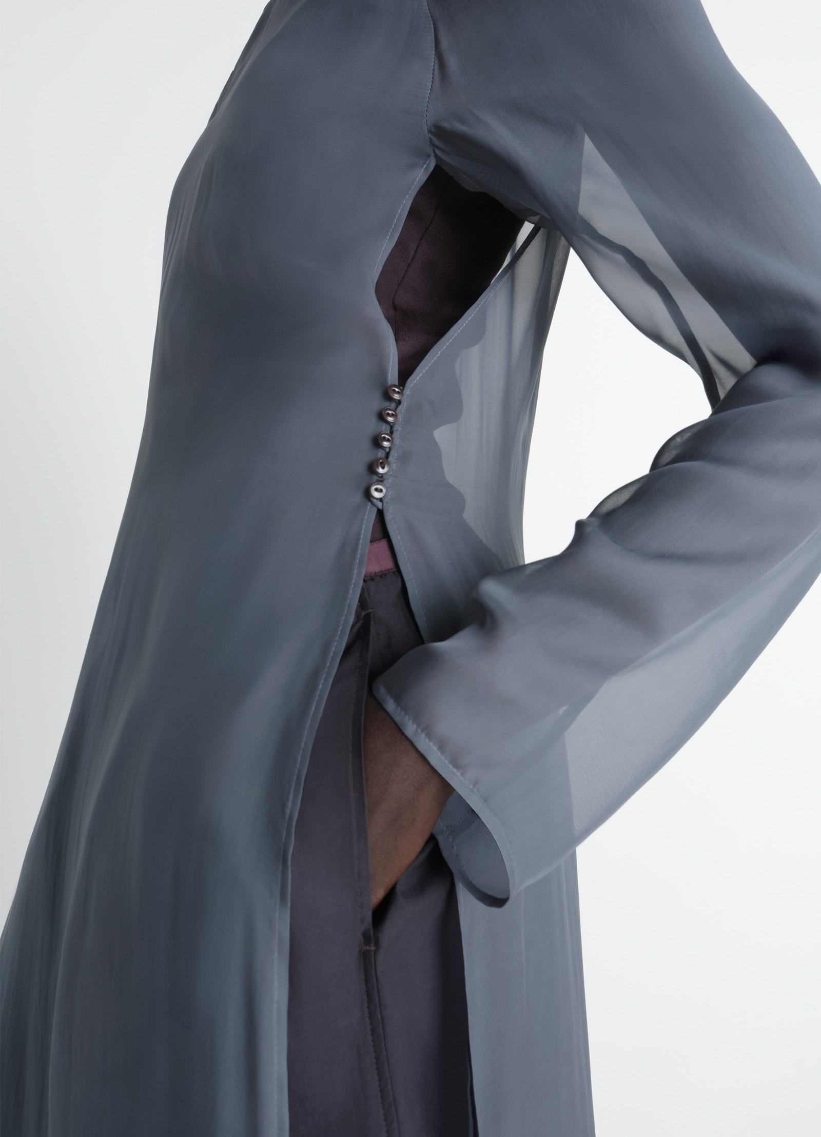 Dress with slits in transparent cup in transparent cupro, model shot, close-up side view button side detail