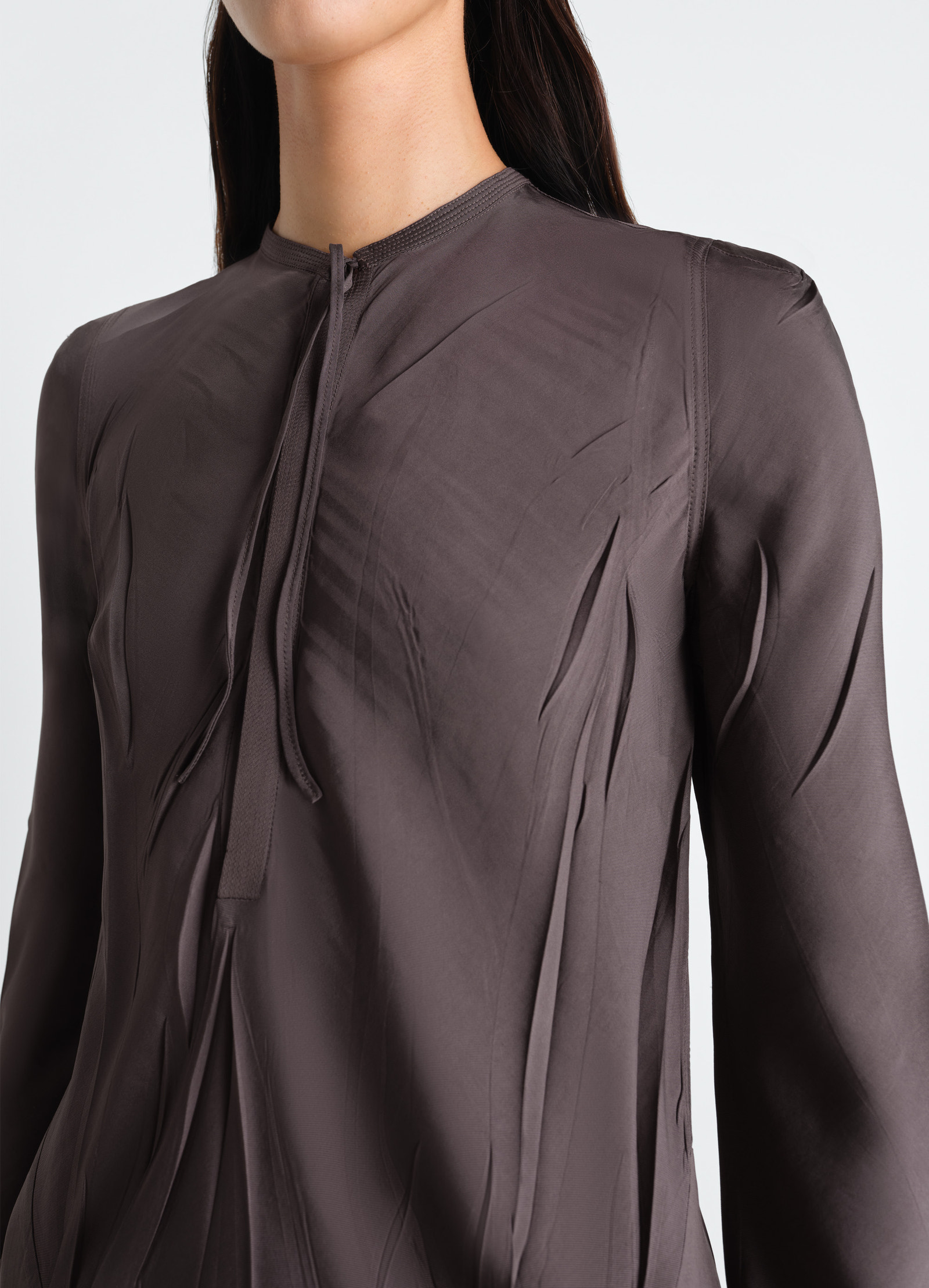 Creased bias dress in poly viscose twill, model shot, close-up view crease texture, tie-neck