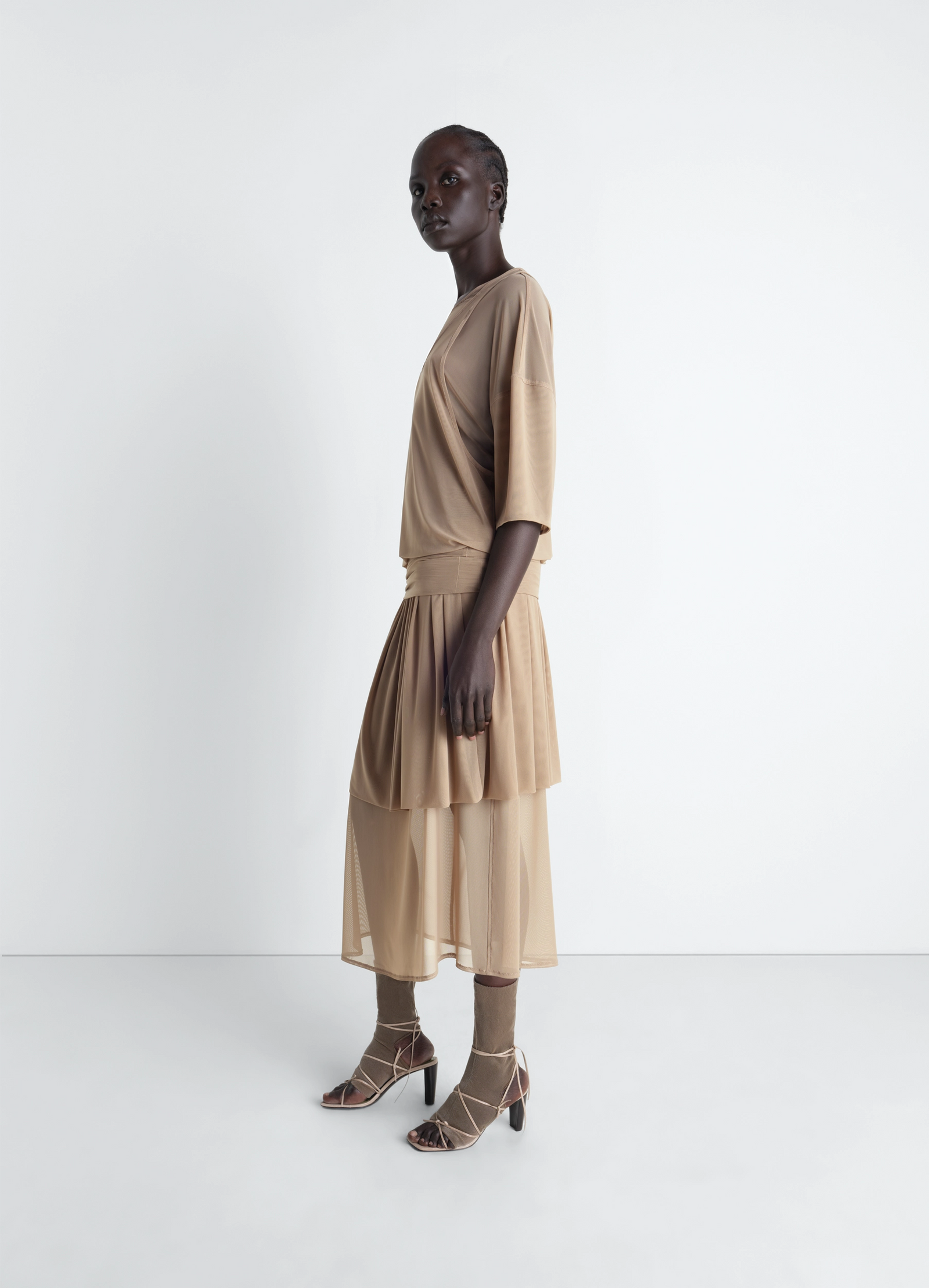 Double layer dress in mesh in transparent mesh, model shot, side view asymmetric hem elegant