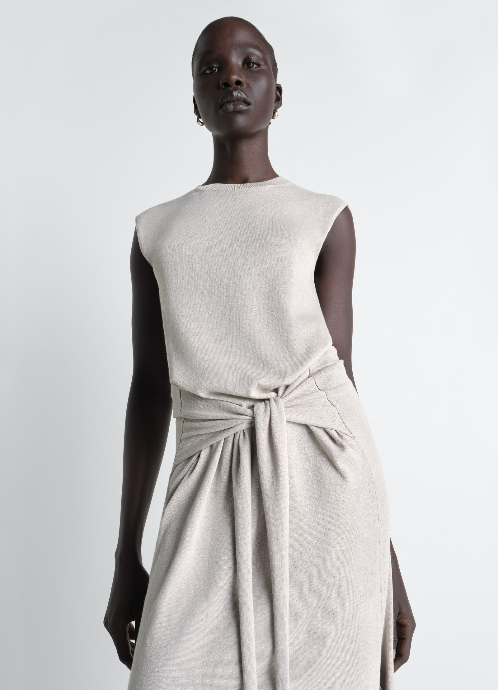 Sleeveless knotted dress in fine cotton crepe, model shot, side detail view knotted waist drape