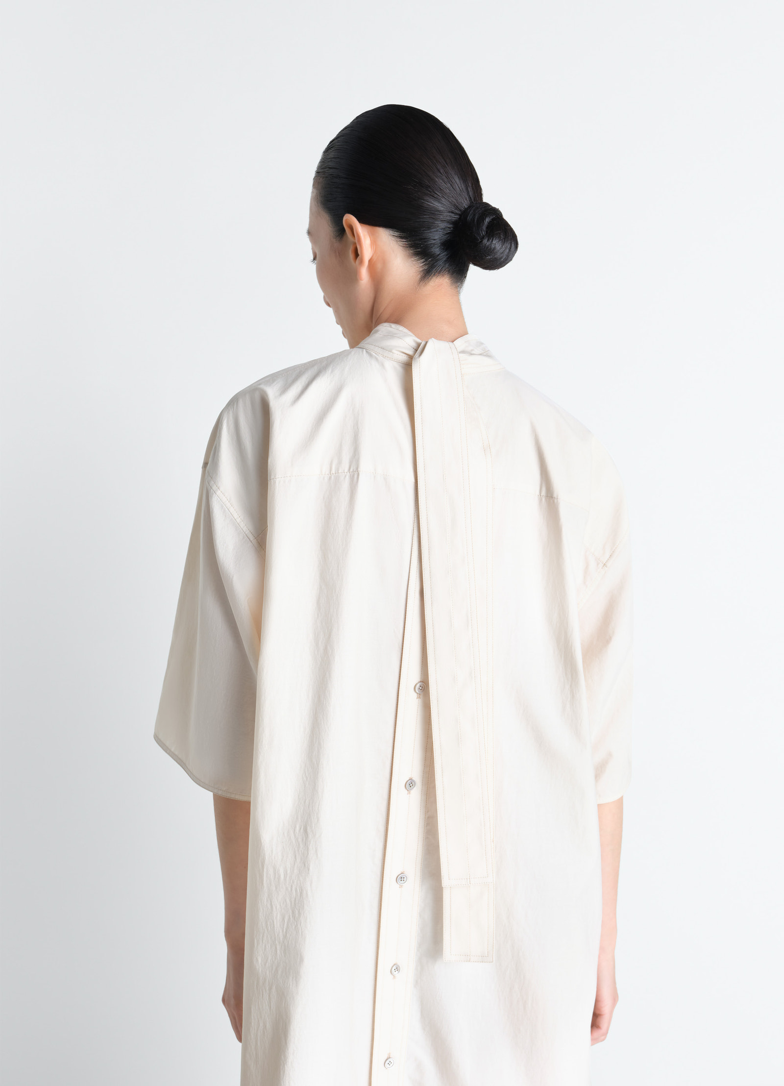 Reversible tube dress in washed cotton silk, model shot, rear three-quarter view button-up back with draped scarf