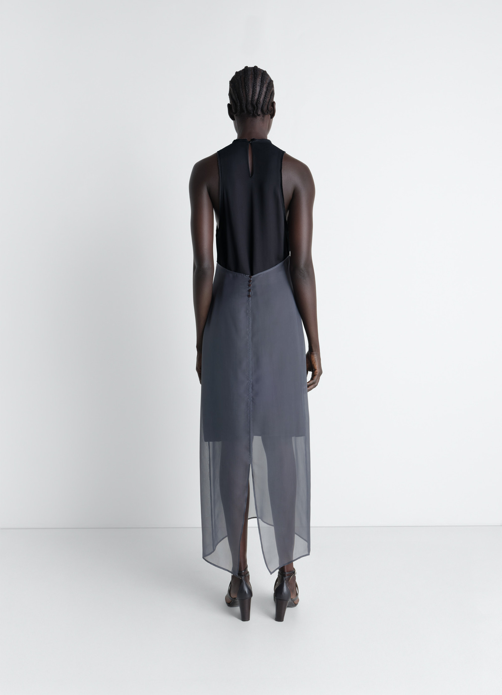 Lemaire column dress in crepe de chine viscose, model shot, three-quarter back view sheer layered hem