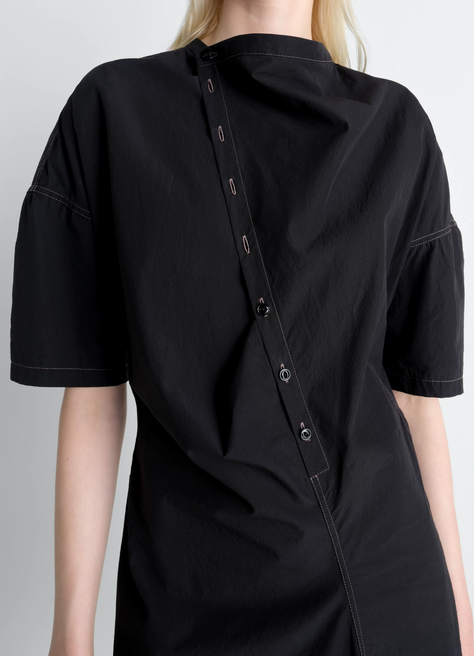 Lemaire soft collar dress in crepe cotton, model shot, close-up side view asymmetric button placket