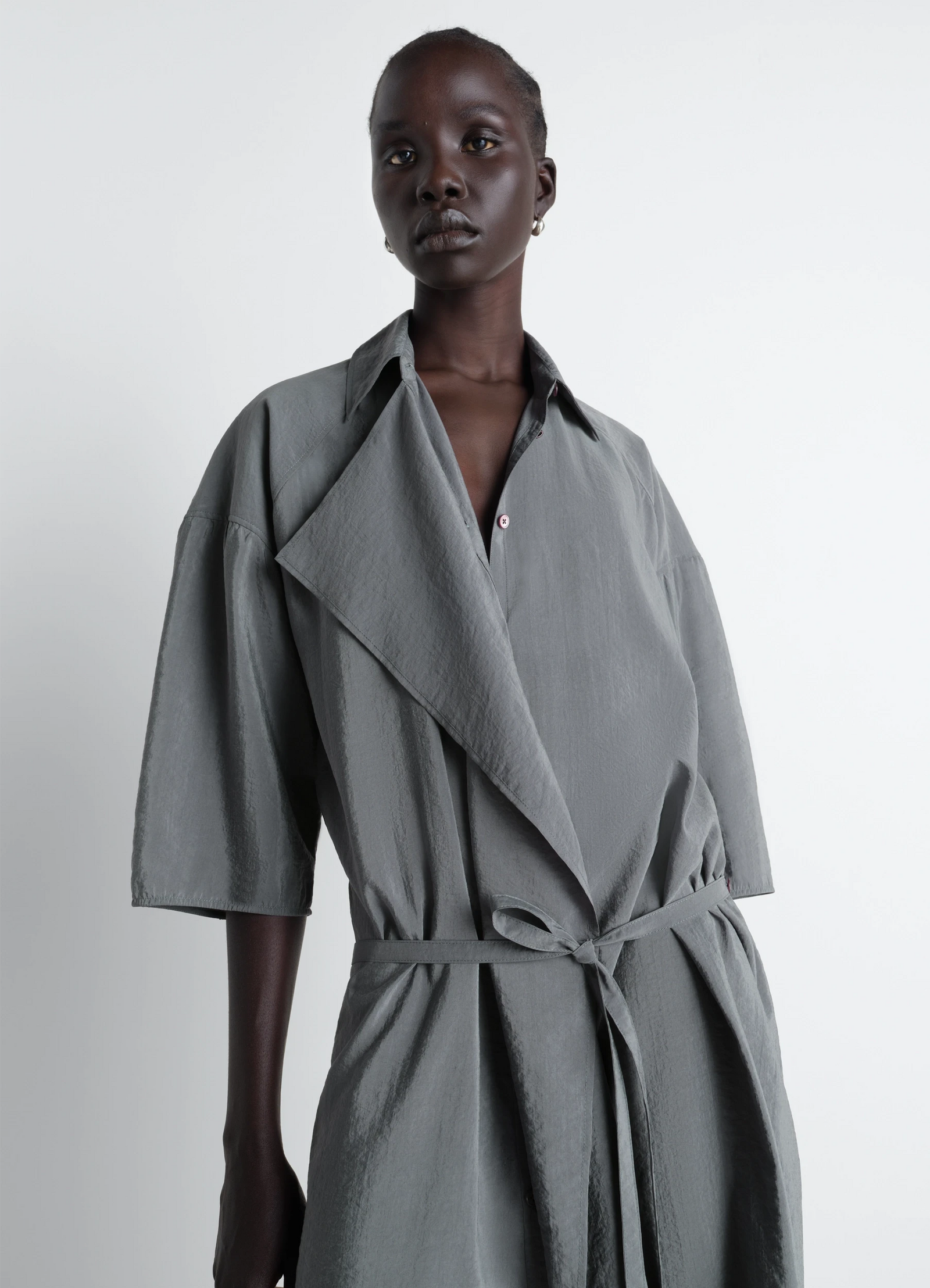 Lemaire asymmetrical shirt dress in dry silk, model shot, three-quarter view asymmetrical collar, belted waist