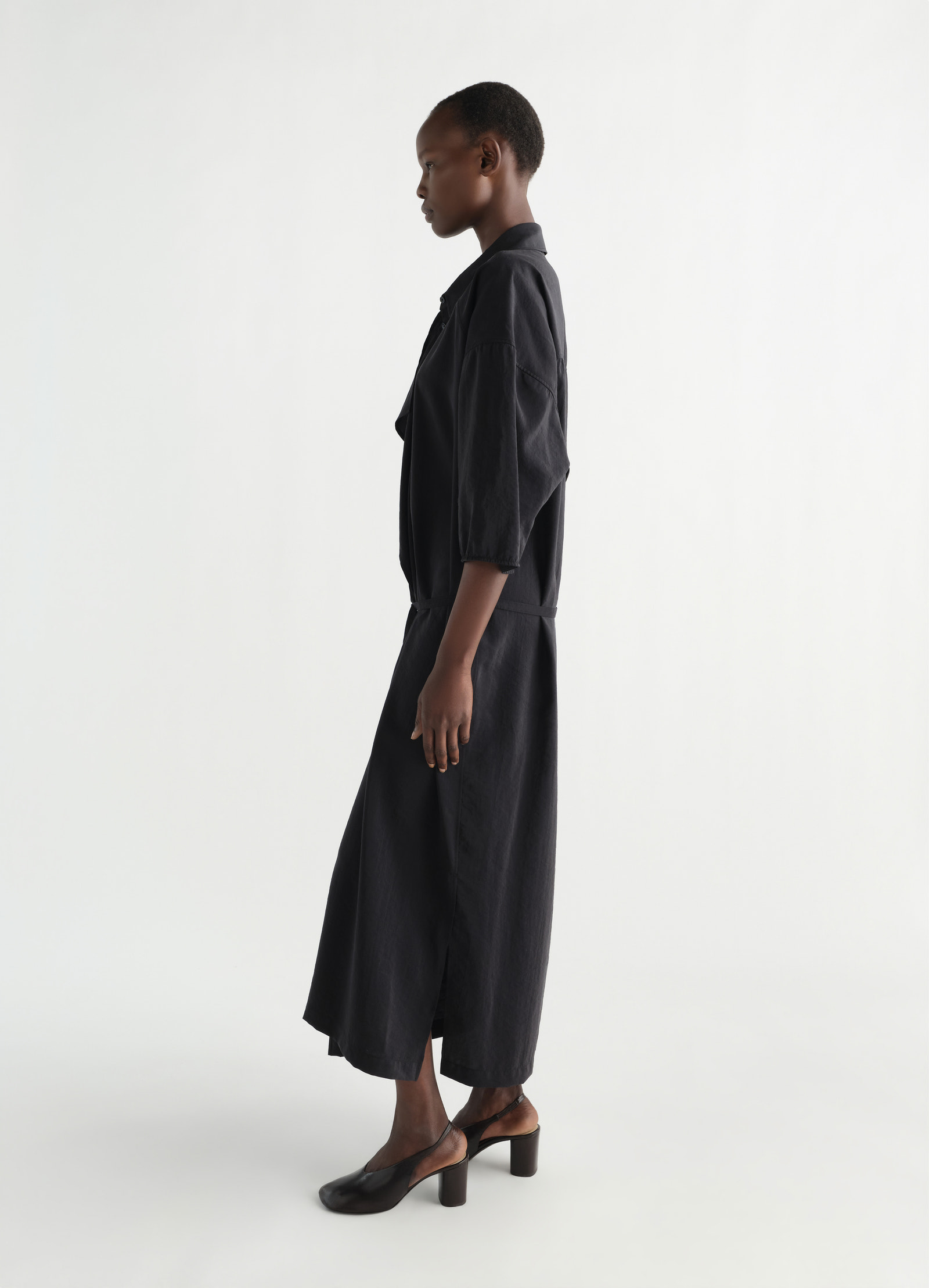 Asymmetrical shirt dress in dry silk, model shot, side profile view mid-length open collar