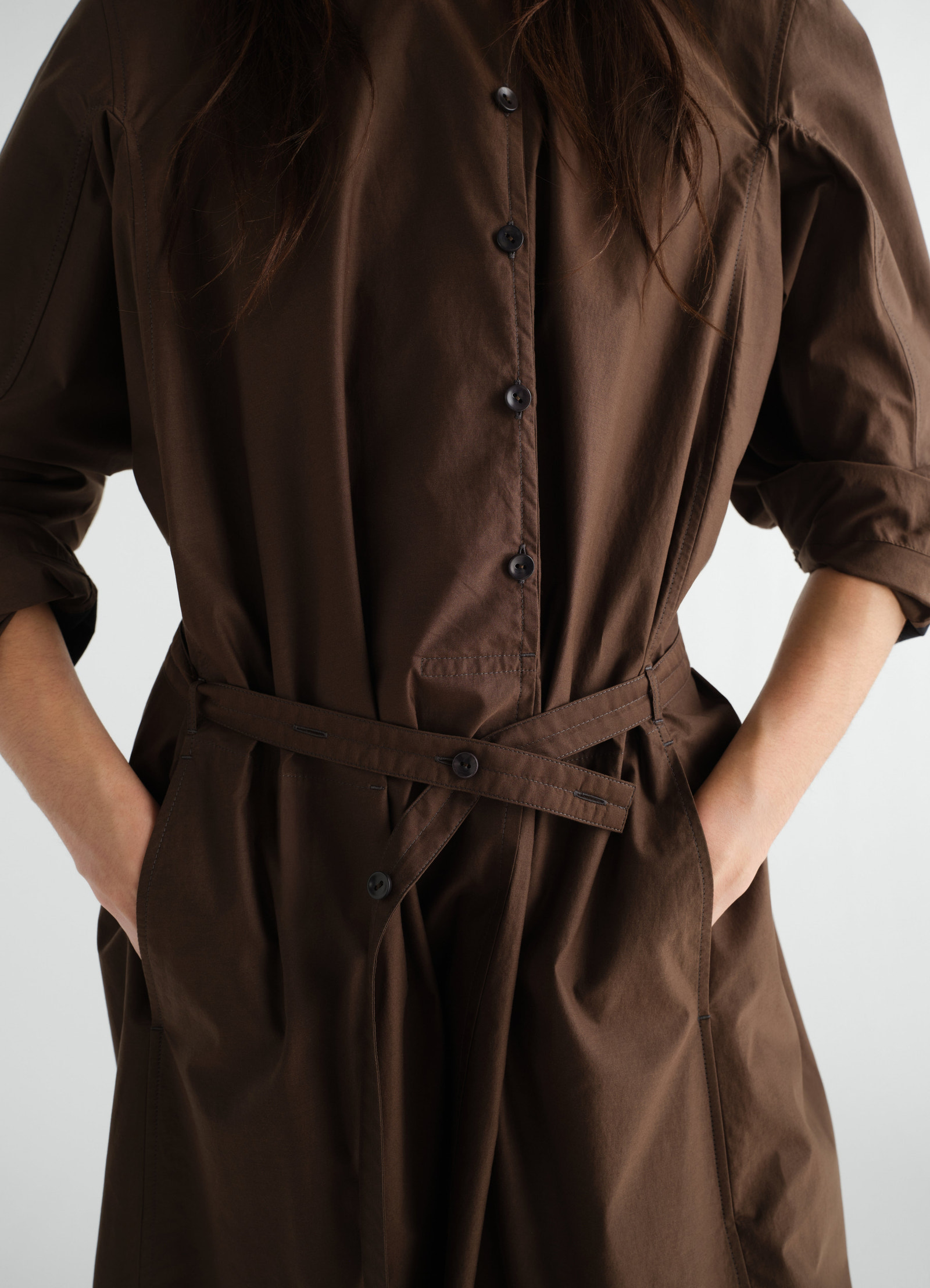 Sailor dress in washed brown cotton and silk blend with button front and belt worn by a model lemaire