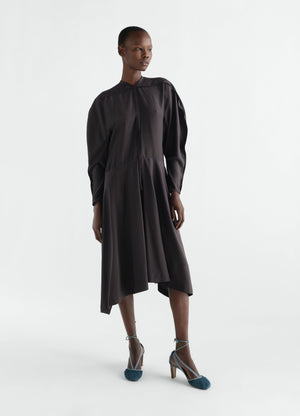 Midi dress in black silk viscose cloth lemaire worn by a model front view with asymmetric hem and long sleeves