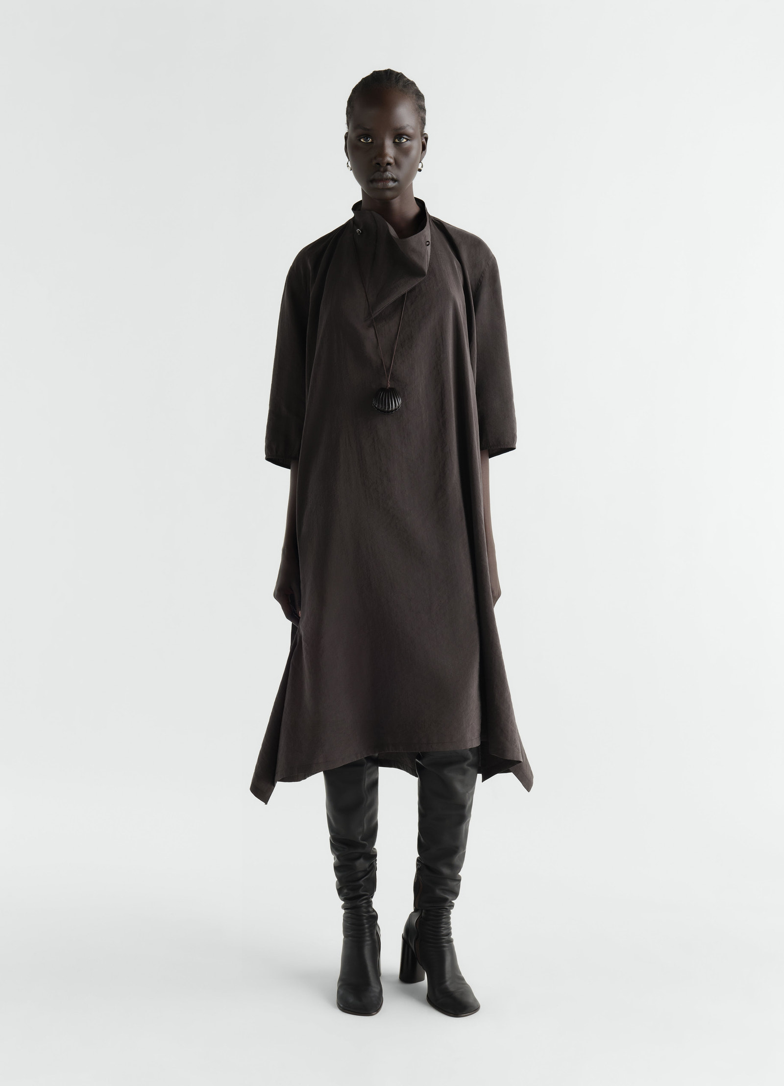 Soft-collar brown dry silk dress worn by model with black boots lemaire front view on white background