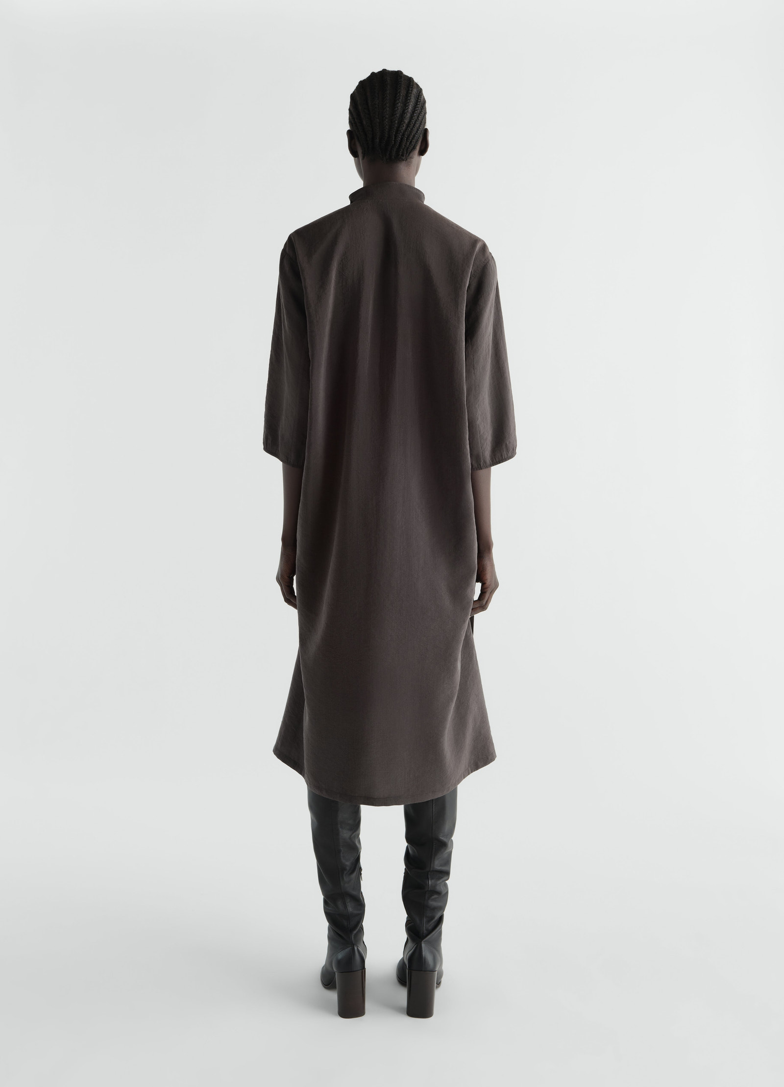 Soft-collar dark brown dry silk dress by lemaire worn by model back view with elbow sleeves and midi length