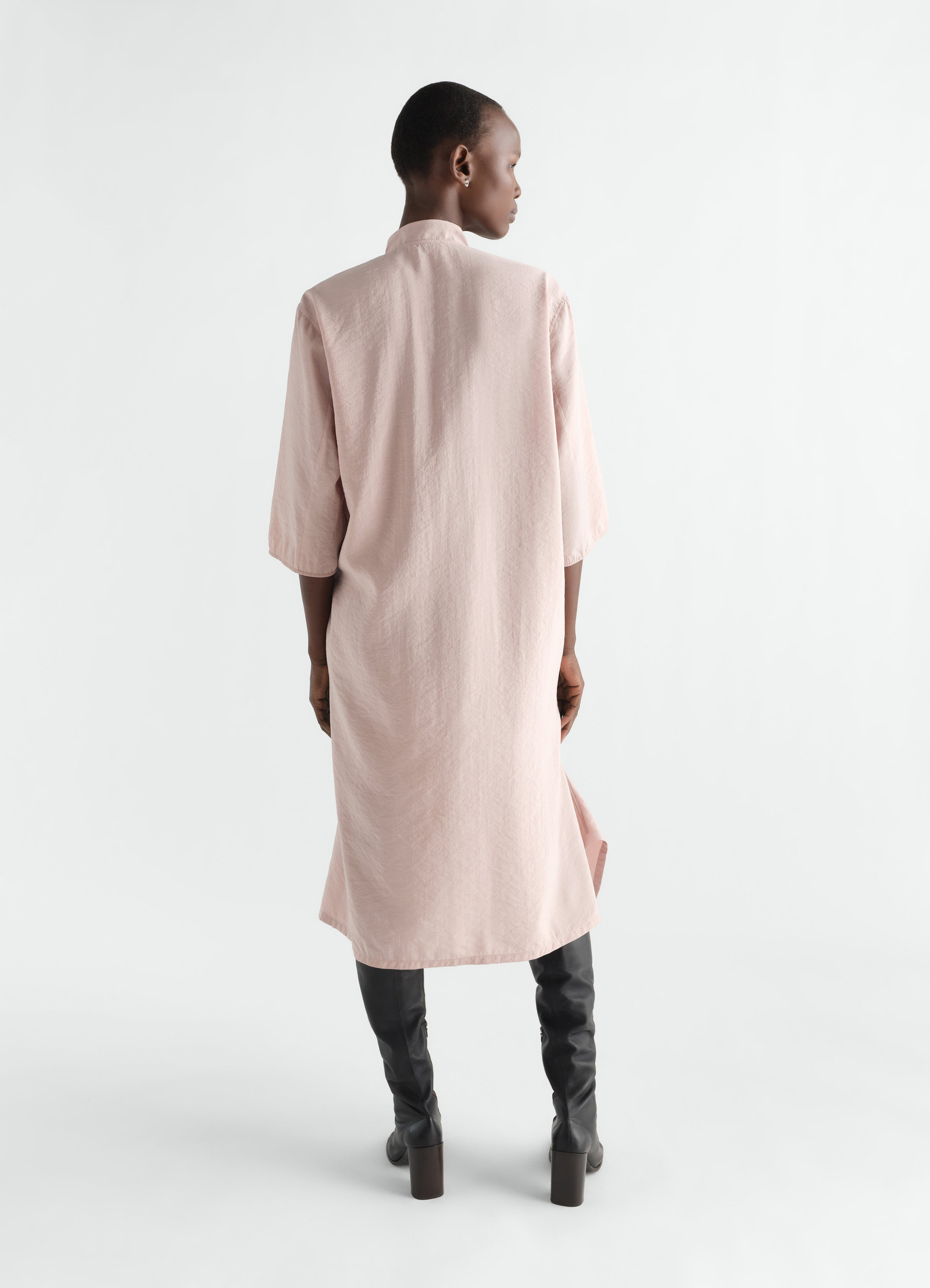 Soft-collar dry silk pink dress by lemaire worn by model back view with elbow-length sleeves and side slit