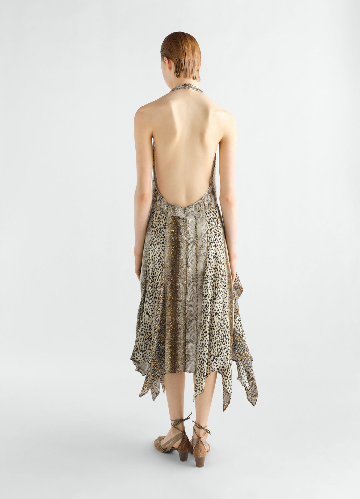 Panelled feather printed viscose dress in neutral tones by lemaire worn by model back view with handkerchief hem