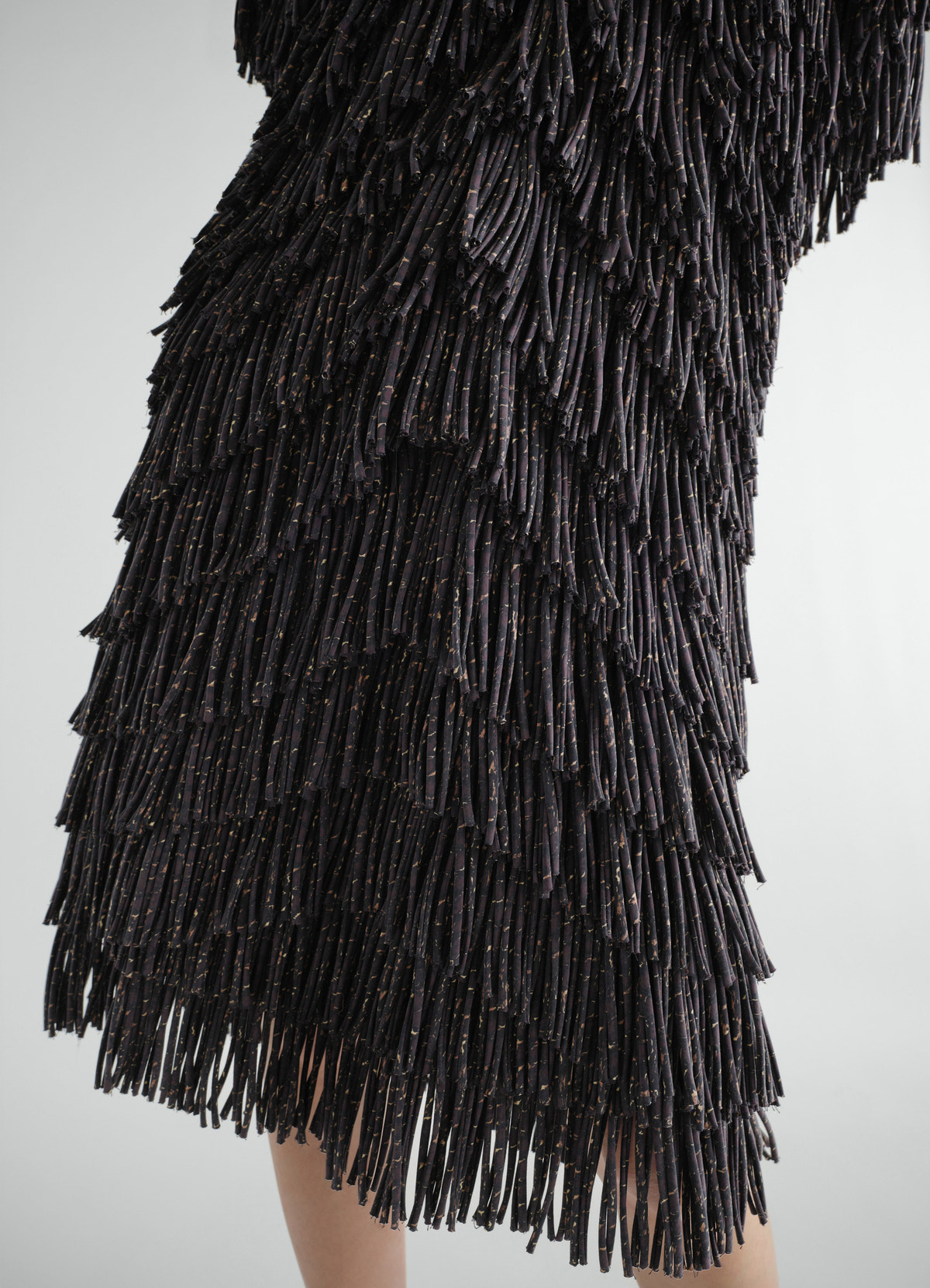 Fringed snake print dry silk dress lemaire layered fringe detail worn by model close-up