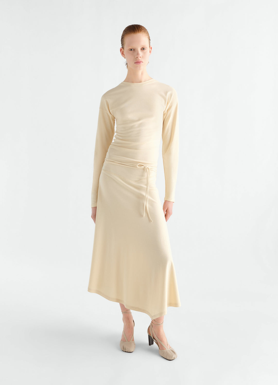 Fluid long-sleeve beige jersey crepe dress with tie waist worn by model front view LEMAIRE