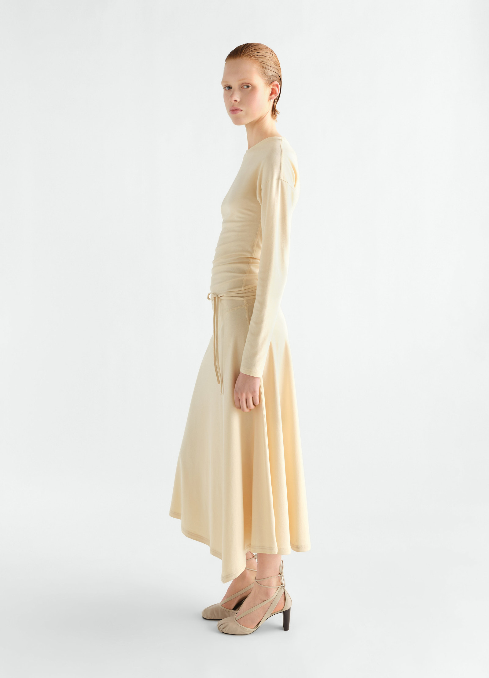 Fluid long-sleeve beige silky jersey crepe dress by lemaire worn by model side view