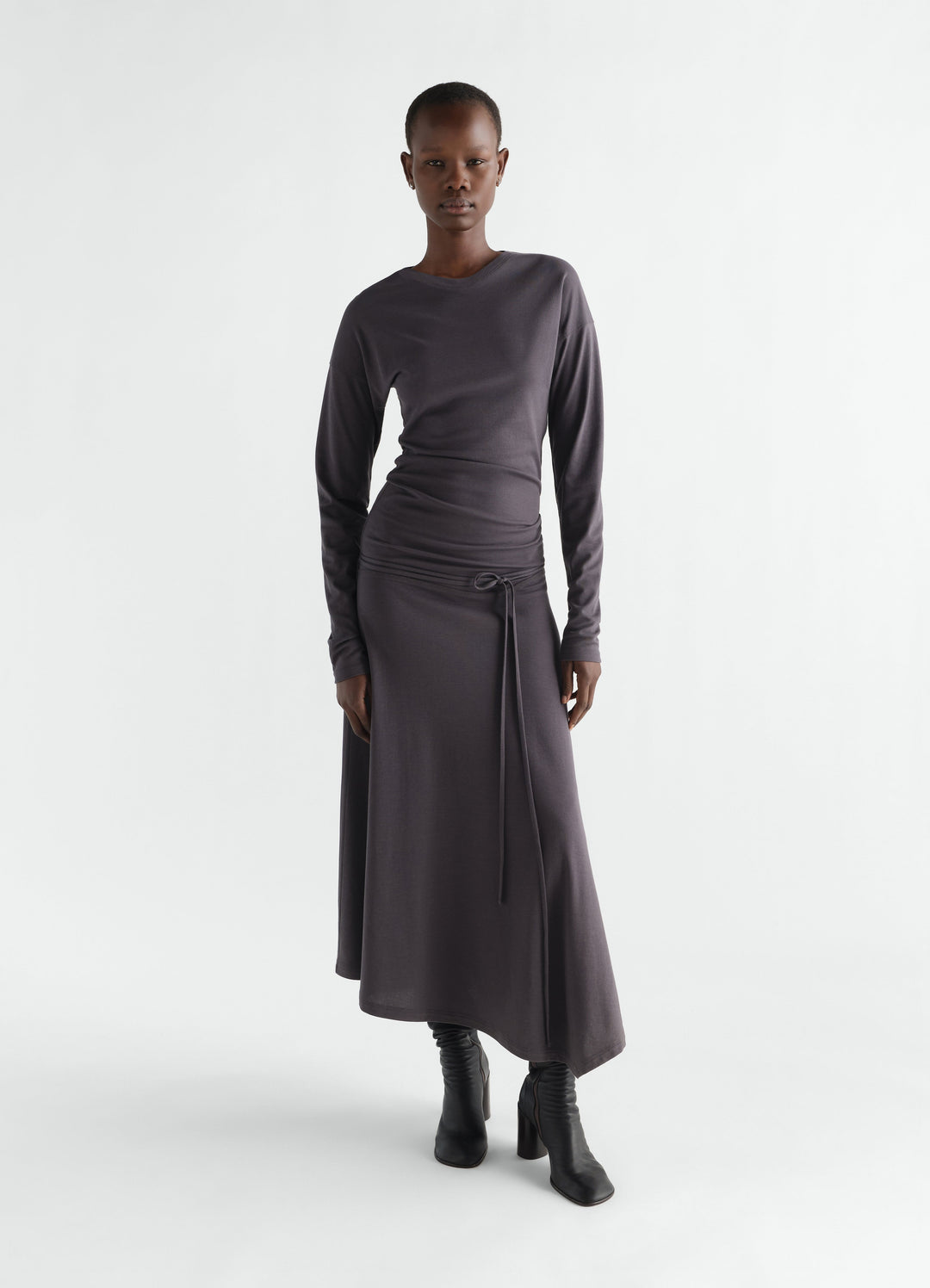 Fluid long-sleeve dark grey silky jersey crepe dress with belt worn by model LEMAIRE