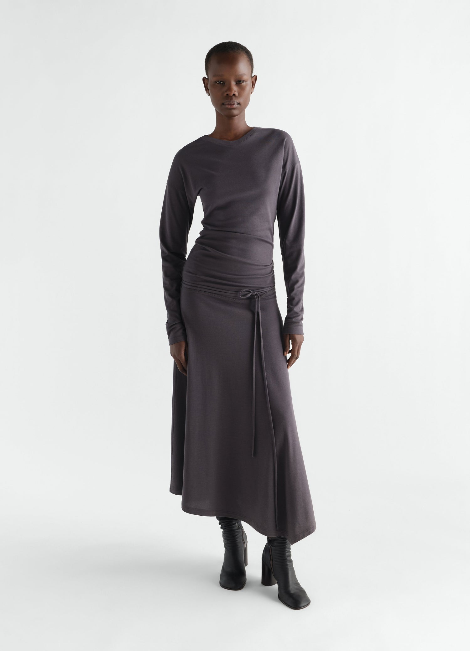 Fluid long-sleeve dark grey silky jersey crepe dress with belt worn by model LEMAIRE