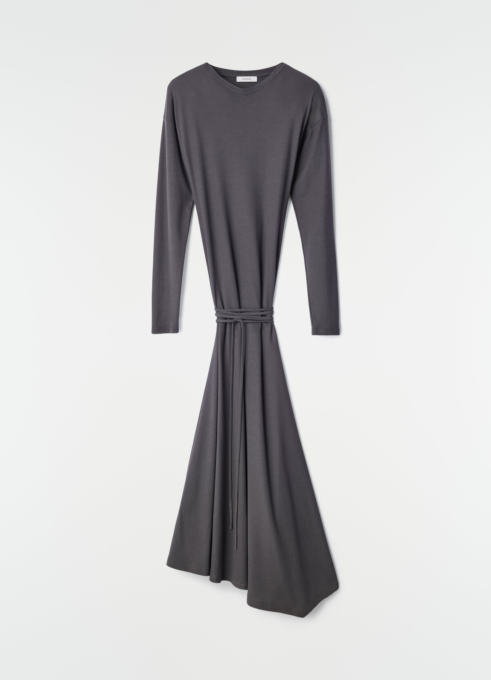 Fluid long-sleeve dark grey silky jersey crepe dress with belt by lemaire on plain white background