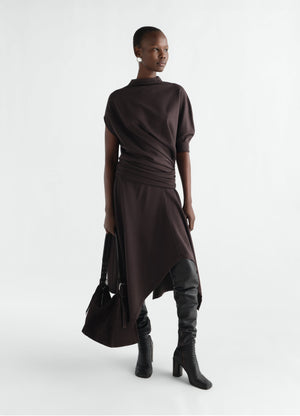 Twisted wool-blend jersey dress in dark brown by lemaire worn by model with black boots and bag