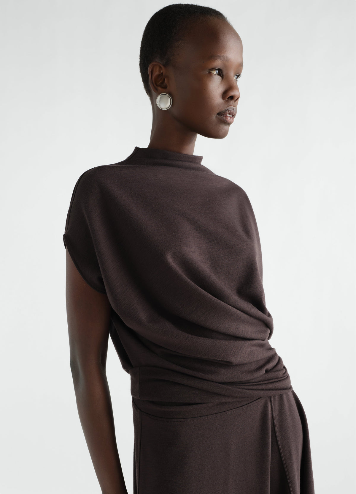 Twisted black wool-blend interlock jersey dress LEMAIRE worn by model side view against white background