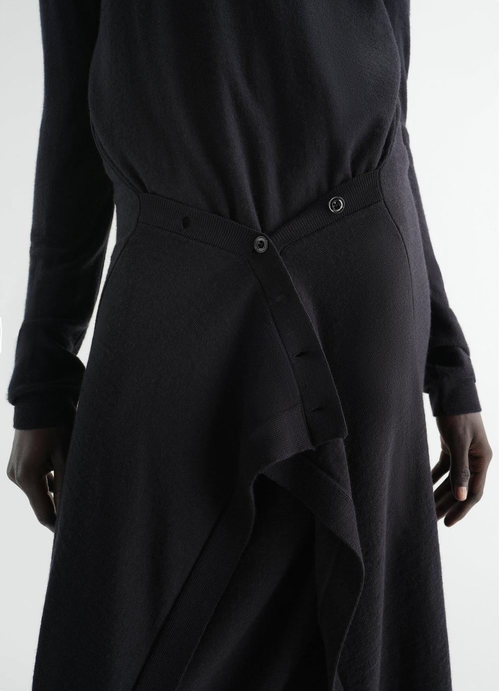 Buttoned black merino wool blend dress LEMAIRE close-up detail worn by a model showing front buttons and fabric texture