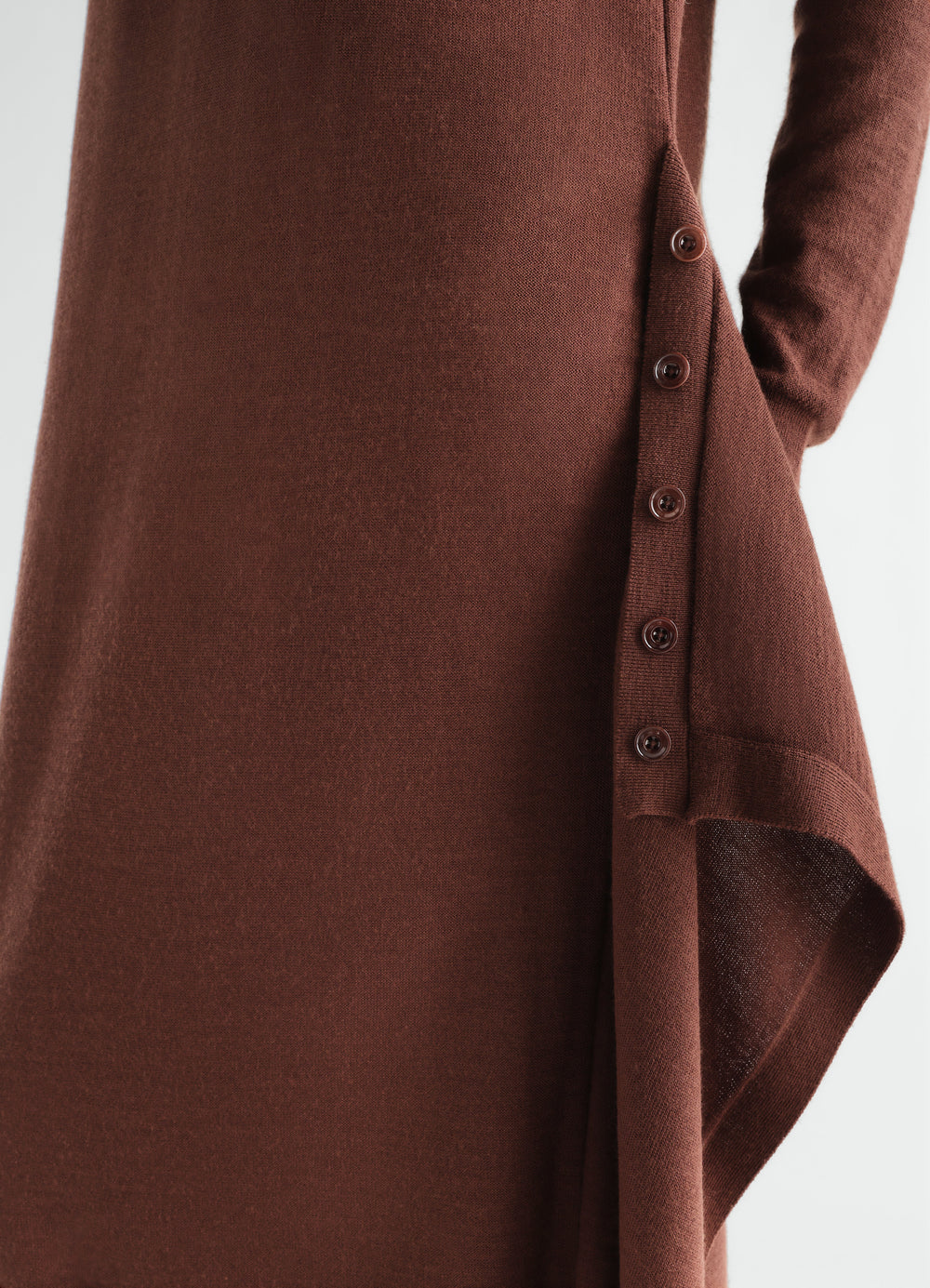 Buttoned brown merino wool blend dress by LEMAIRE close-up of side buttons detail worn by model