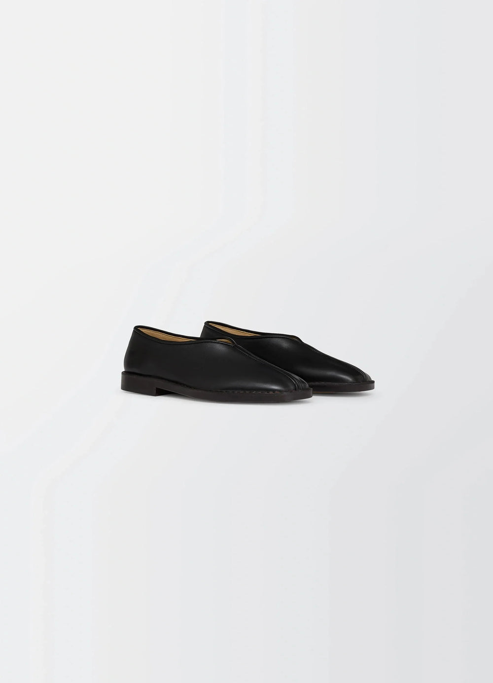 Lemaire Piped Slippers in Black Nappa Leather, product shot, three-quarter view smooth texture, low heel