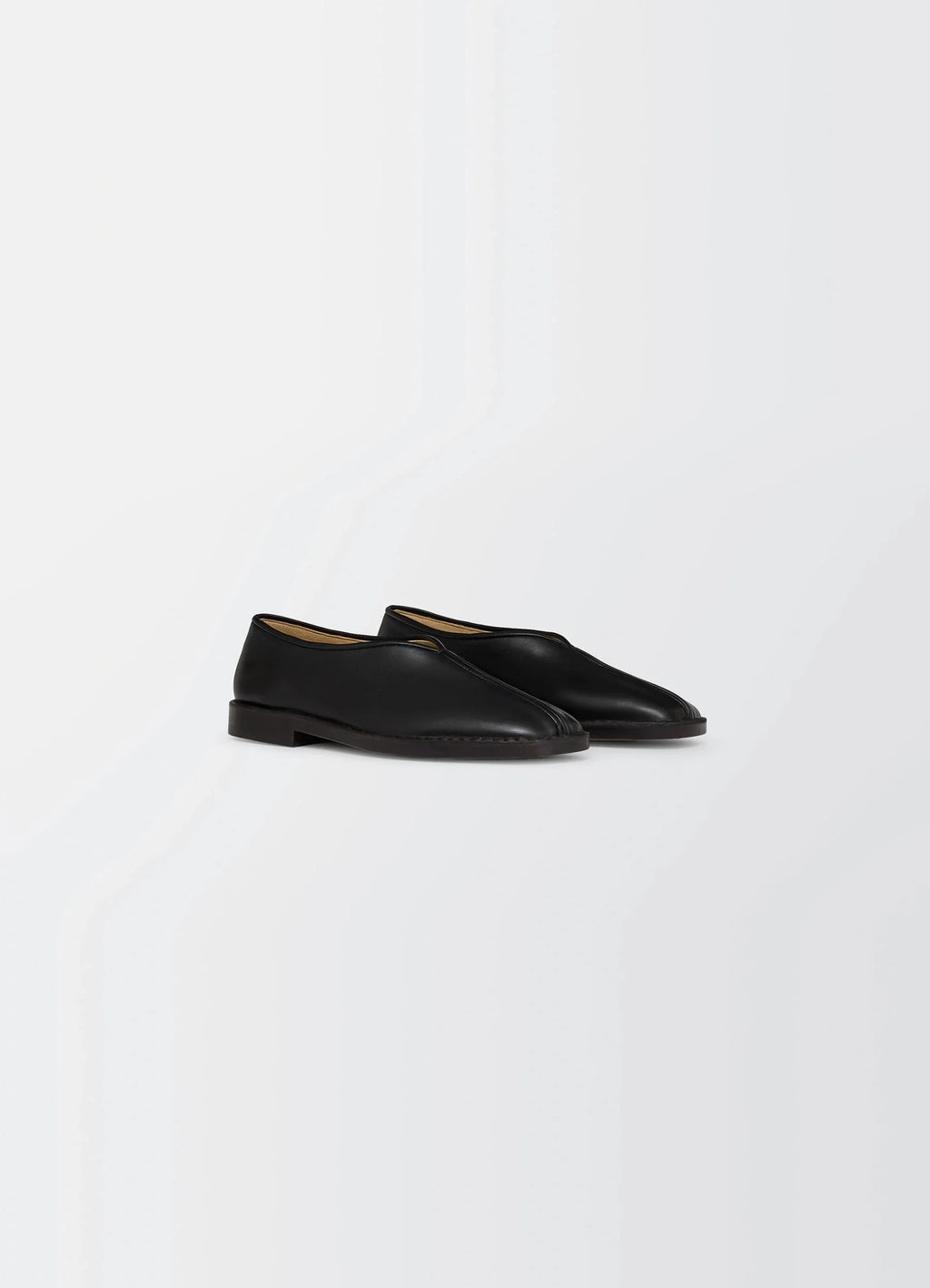 Lemaire Piped Slippers in Black Nappa Leather, product shot, three-quarter view smooth texture, low heel